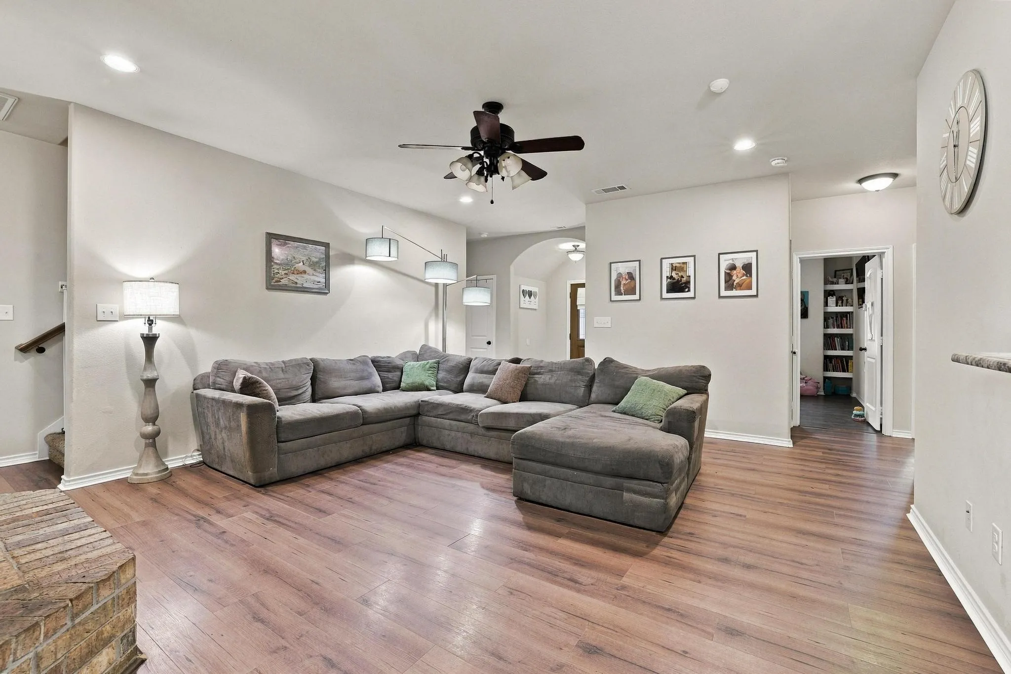Wood-finish flooring throughout, recessed ceiling lighting, ceiling fan, and built-in shelving