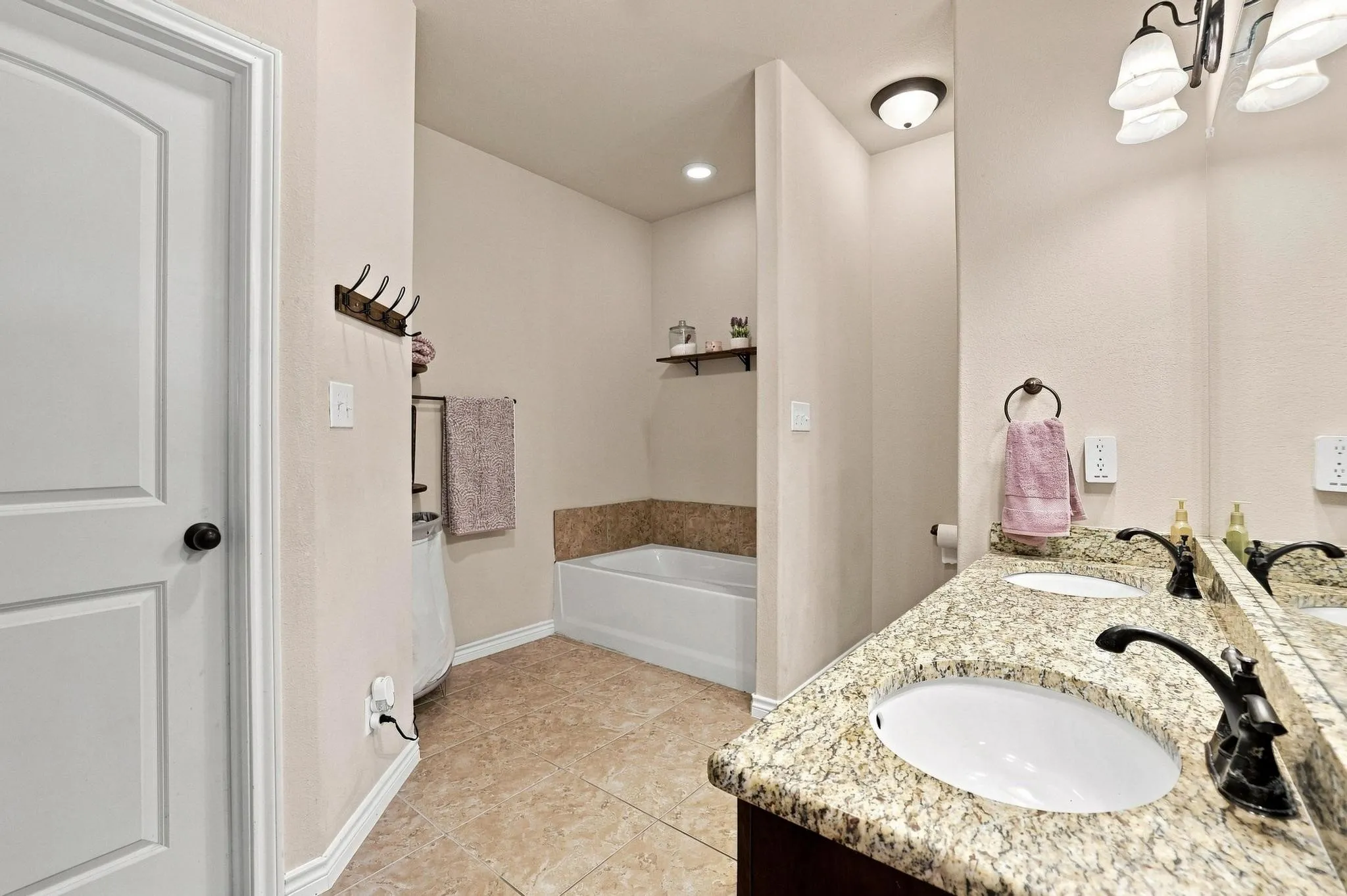 Dual vanity with granite countertop, undermount sinks, and dark bronze fixtures