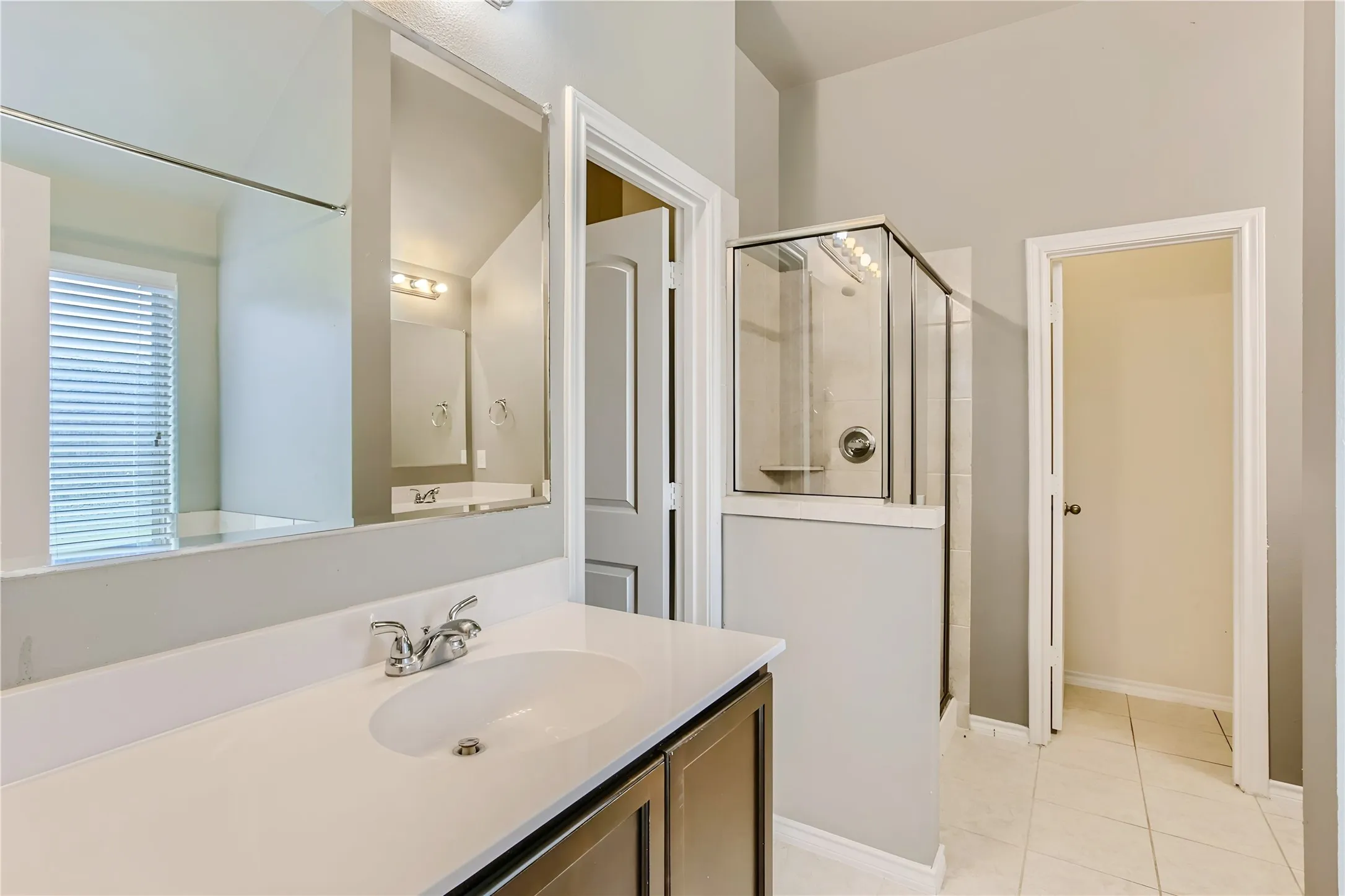Spacious vanity with a basin sink and chrome faucet