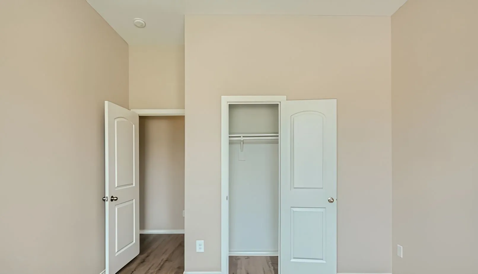 Neutral-toned walls with wood-finish flooring