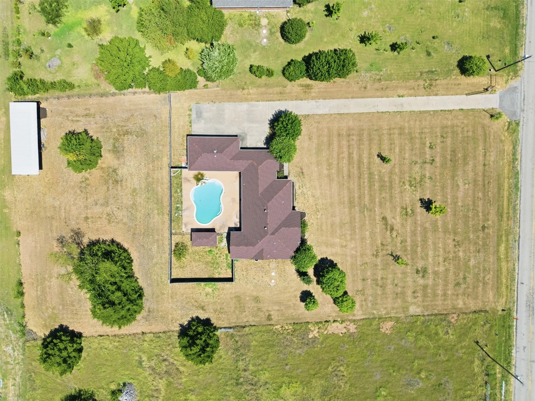 Aerial View detailing the pool and stable.