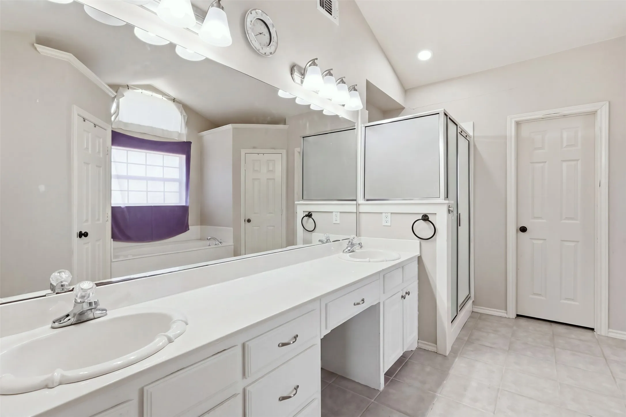 Primary bathroom has double sinks, separate shower and large soaking tub.
