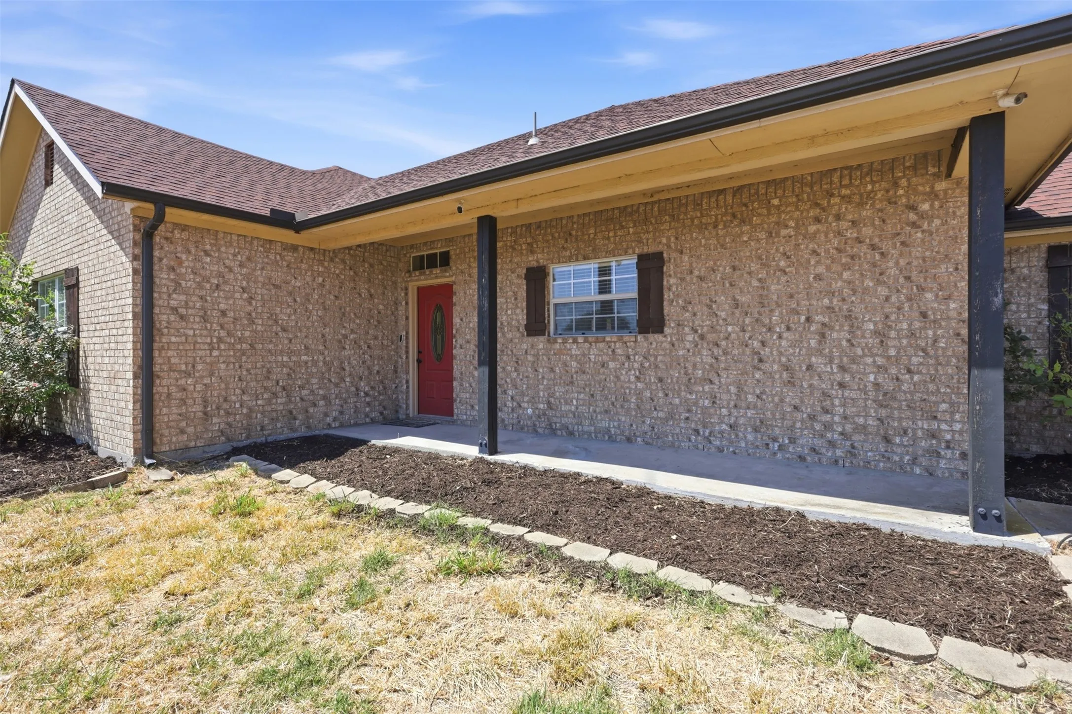 Large covered front porch and defined flower beds welcome you home!