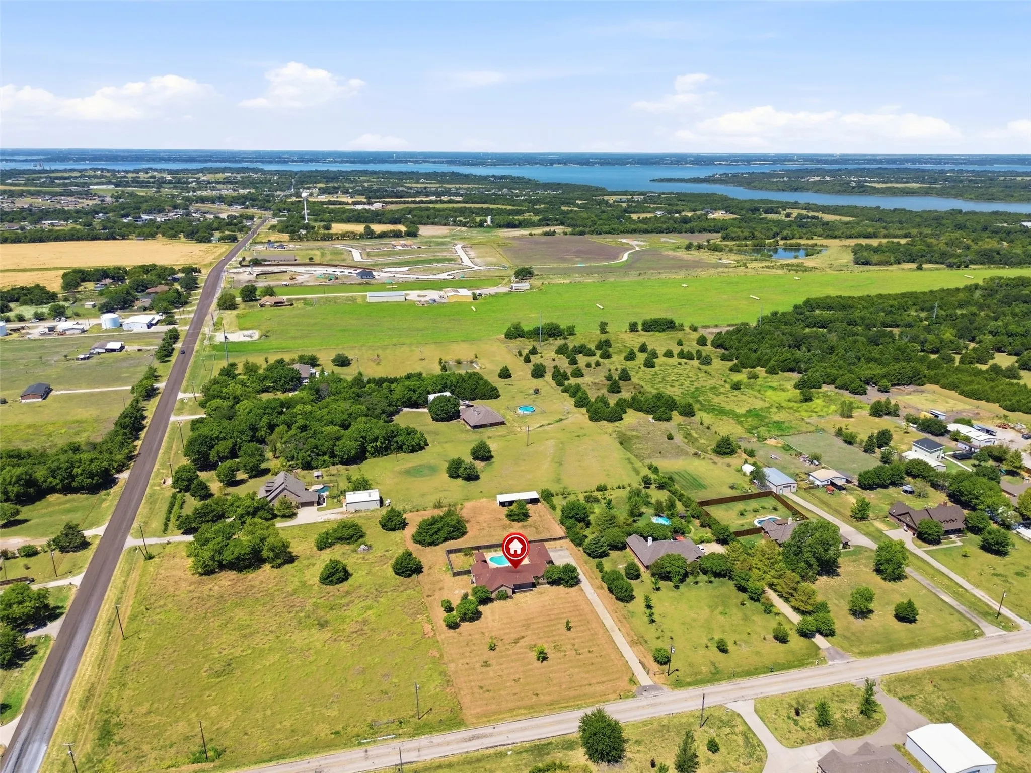 Aerial View shows the property that extends from the driveway to the main road pictured.