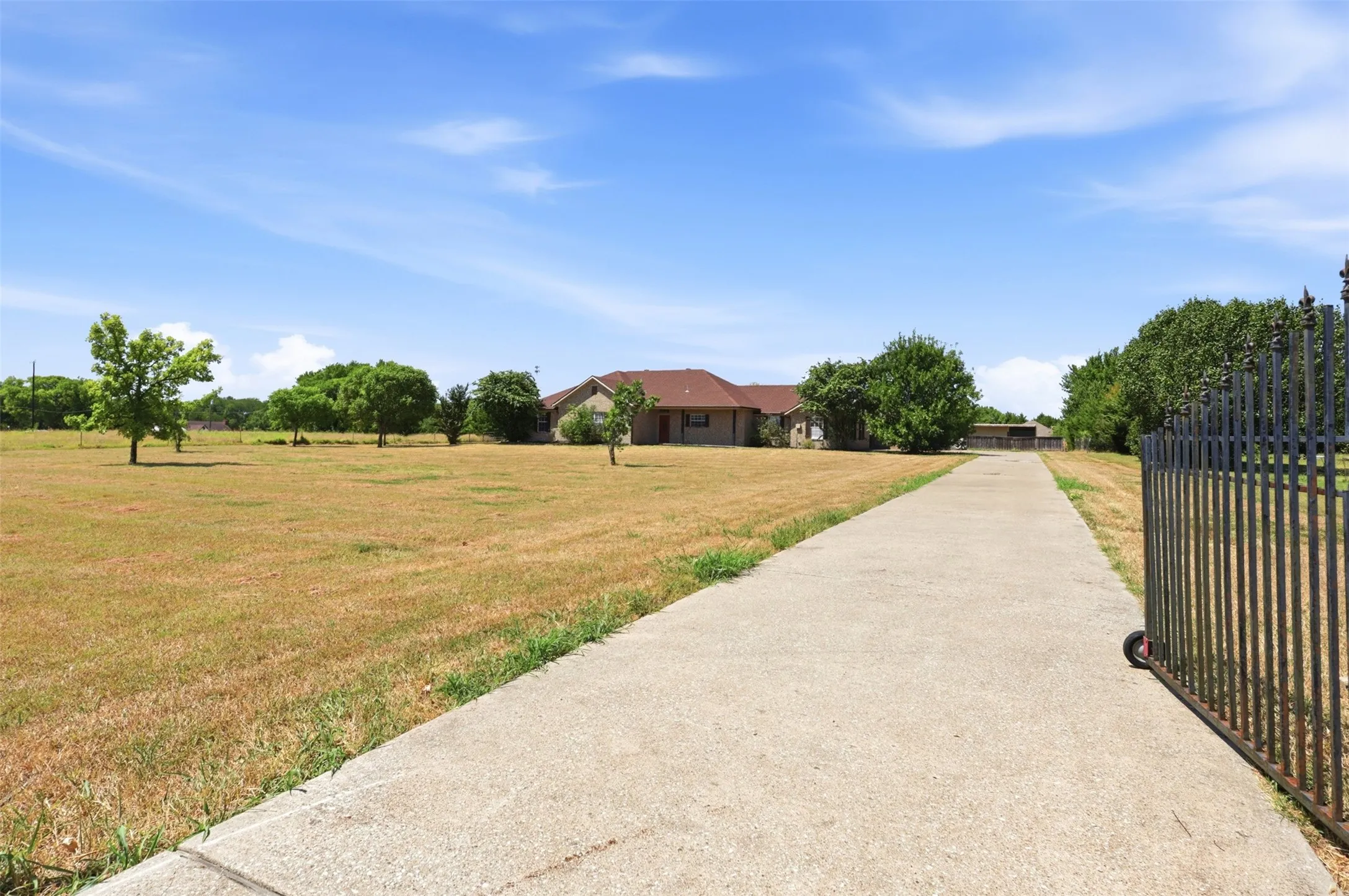 Private wrought Iron gate leads to this beautiful ranch style home on