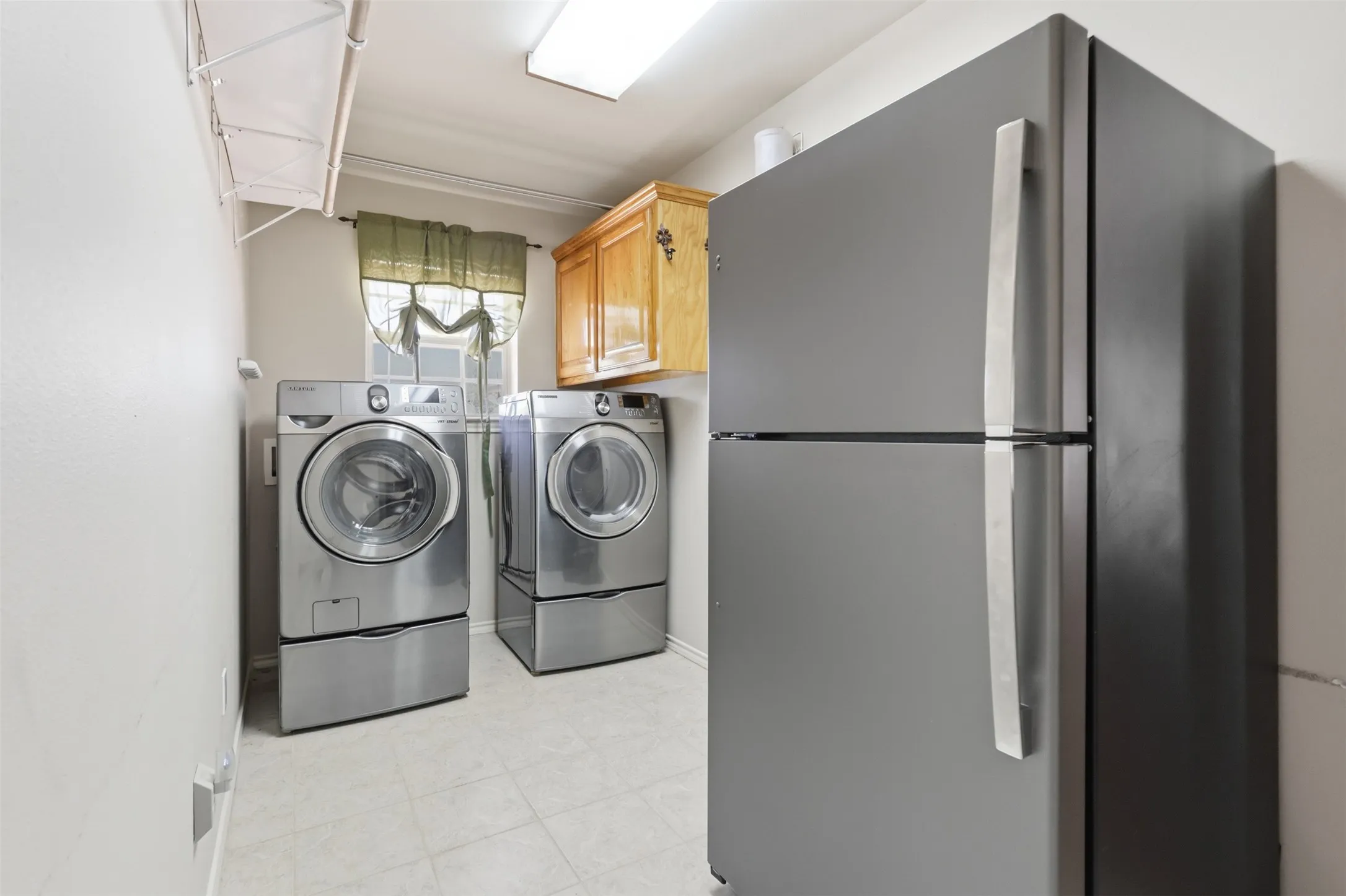 Large utility room allows for second fridge.