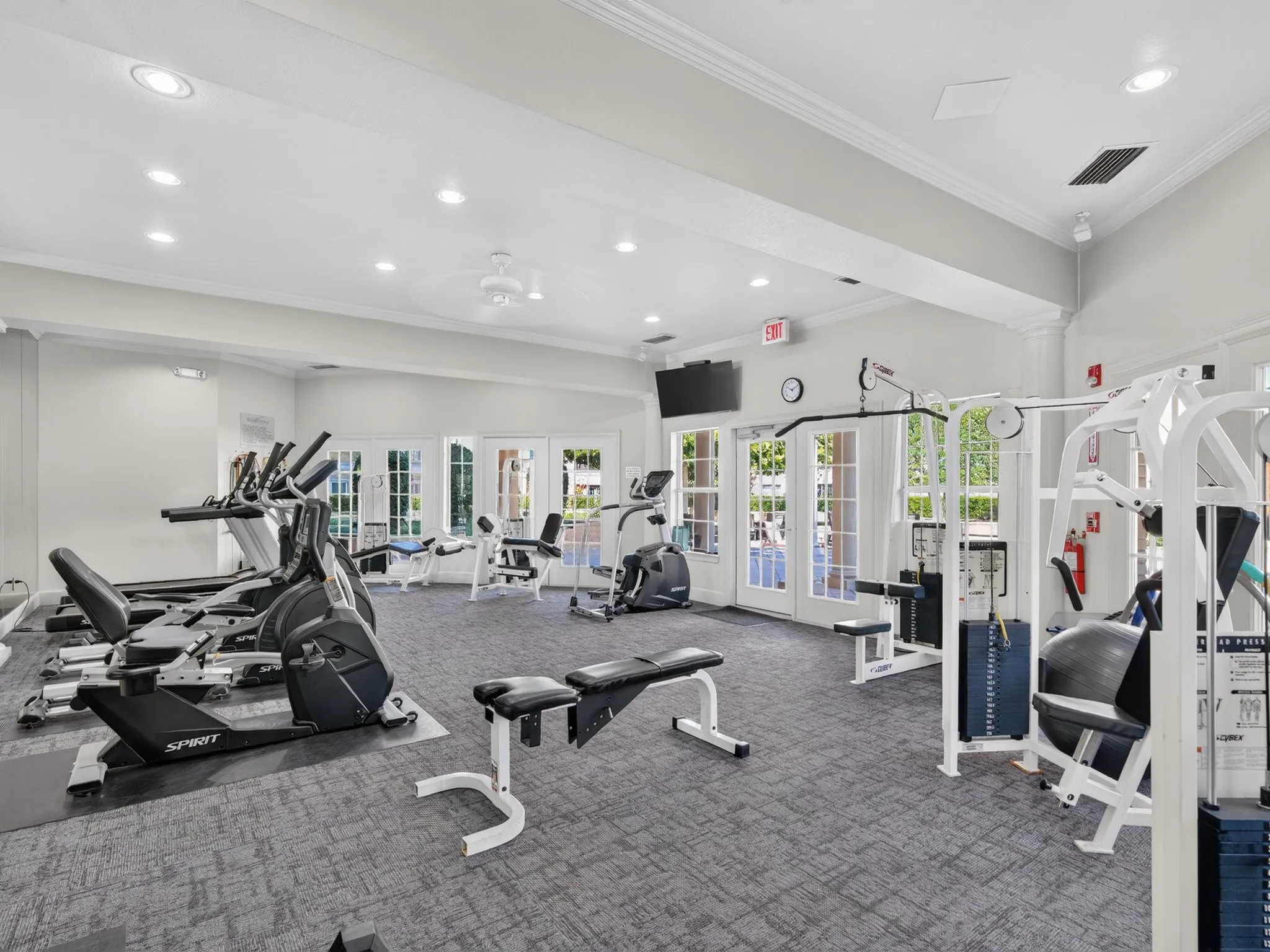 Fitness center with carpet flooring, recessed lighting, and multiple exercise machines