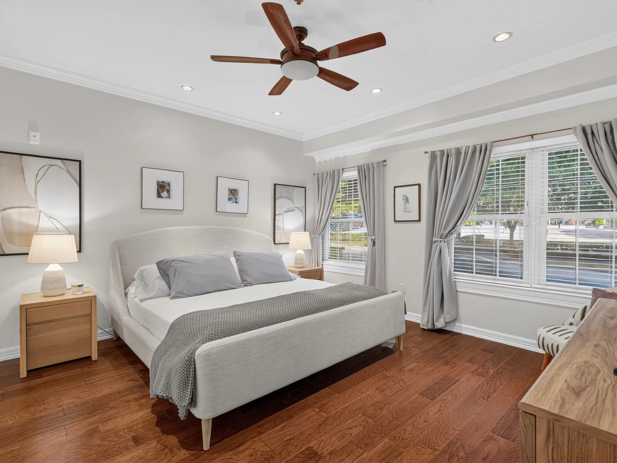 Wood-finish flooring throughout, recessed lighting, ceiling fan, and crown molding