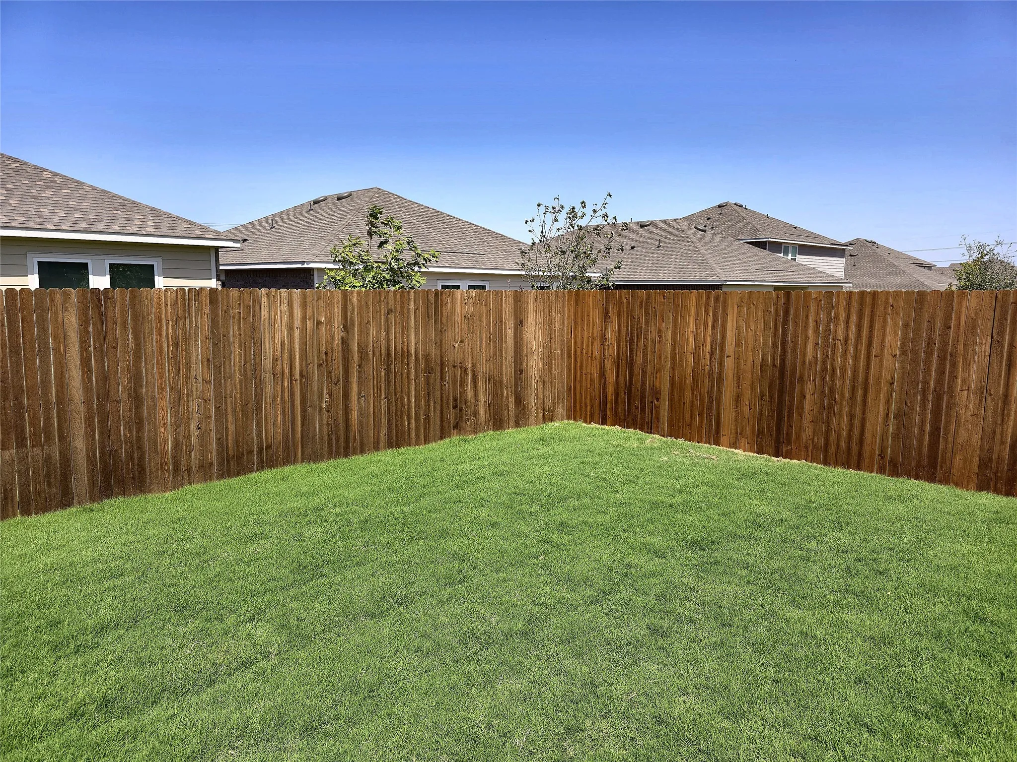 Manicured lawn with a privacy fence