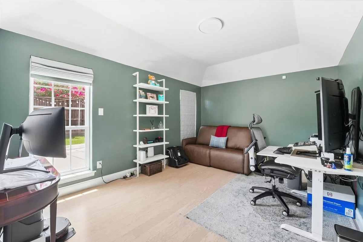 Recessed ceiling with an overhead light fixture, wood-finish flooring, and a window with blinds