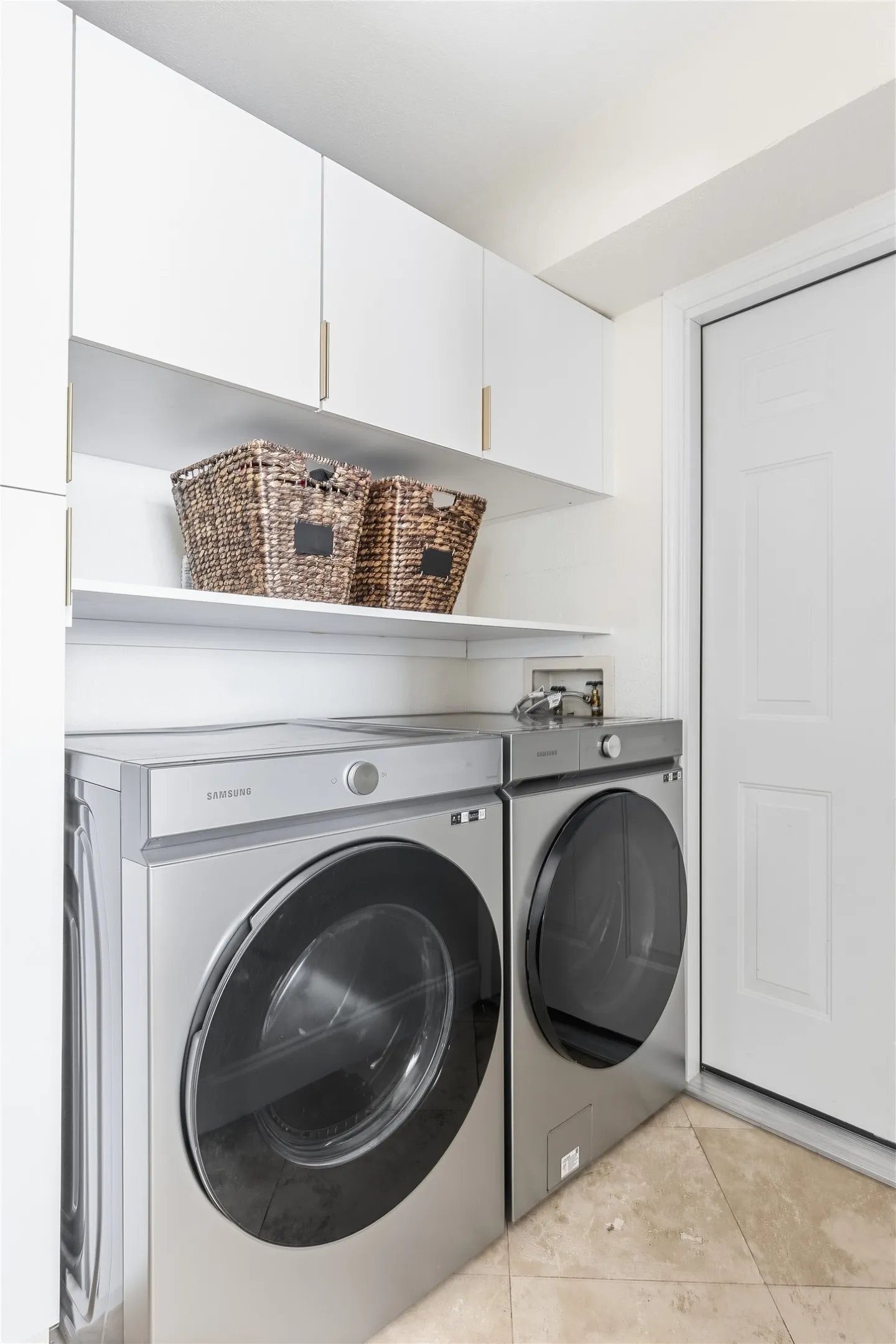 Built-in white cabinetry, open shelving, and tiled flooring