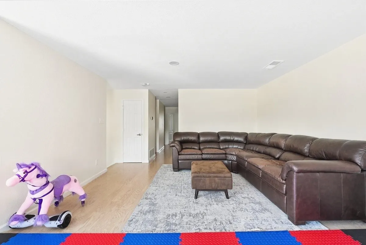 Recessed lighting, light-toned walls, and wood-finish flooring