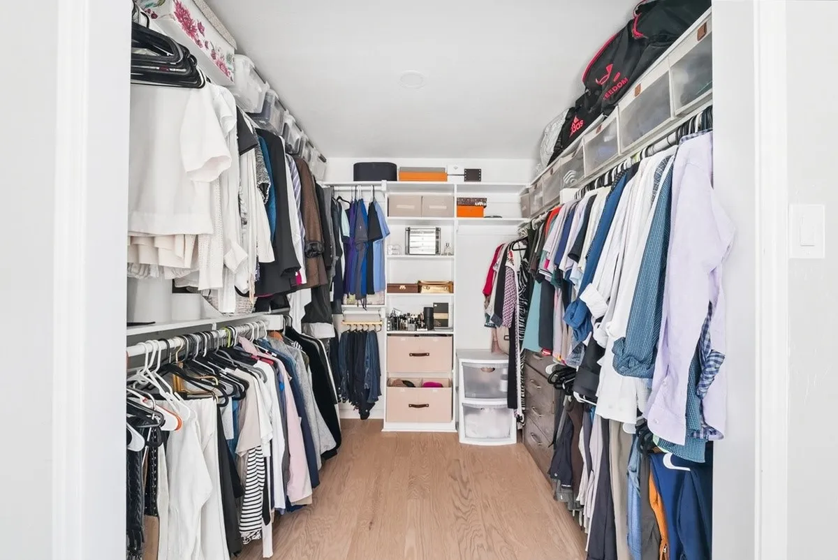 Walk-in closet with wood-finish flooring, recessed lighting, and built-in shelving