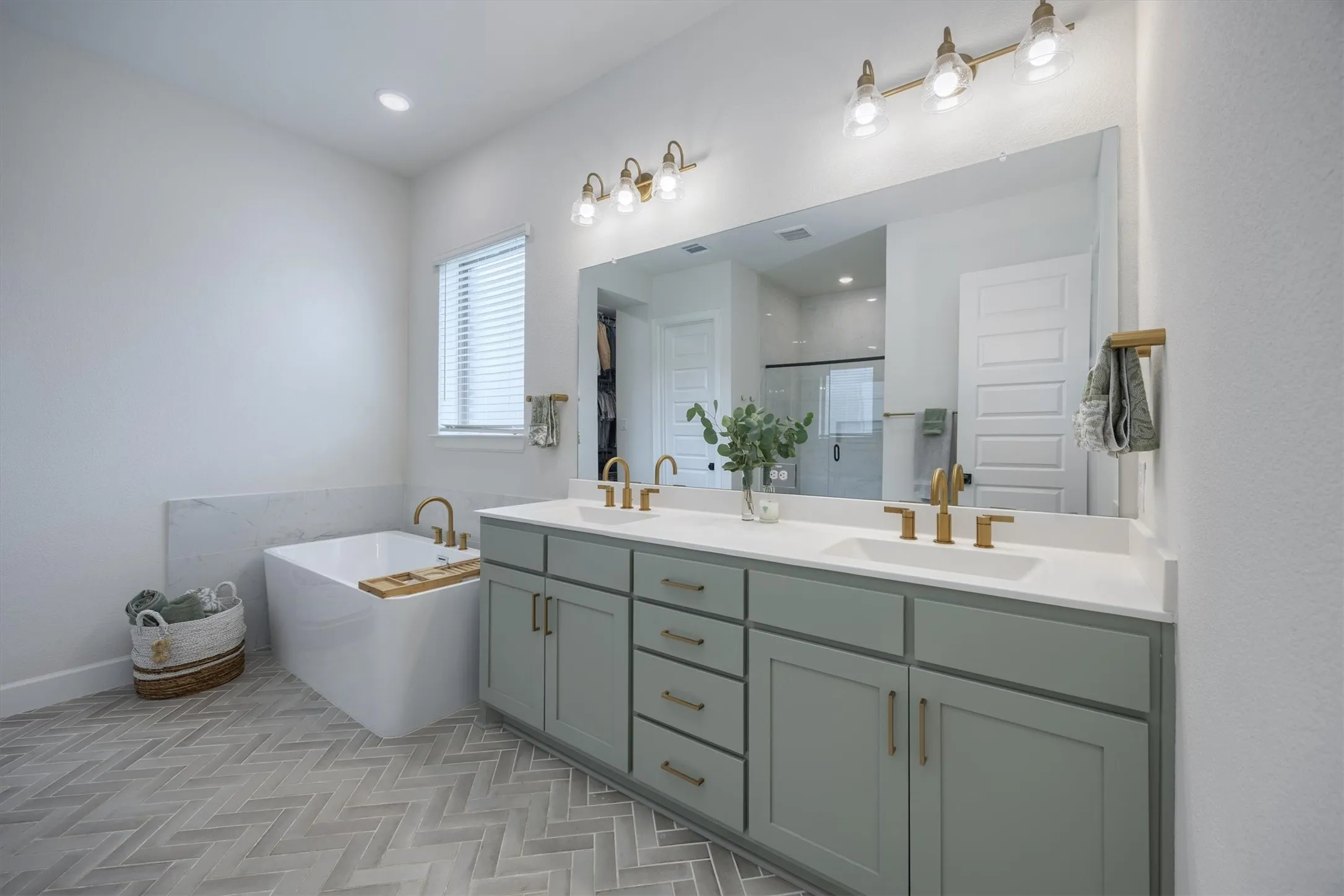 Notice the herring bone flooring! So pretty. The soft green cabinets are gorgeous as well!