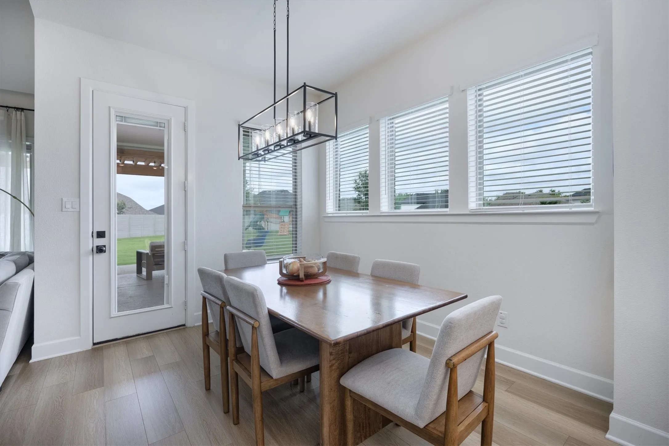 This dining area is situated right off the kitchen with a view of the spectacular backyard and fireplace.