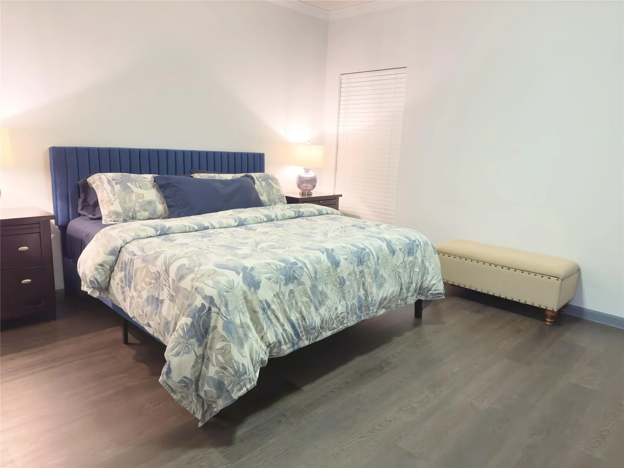 Bedroom featuring crown molding, wood finished floors, and baseboards