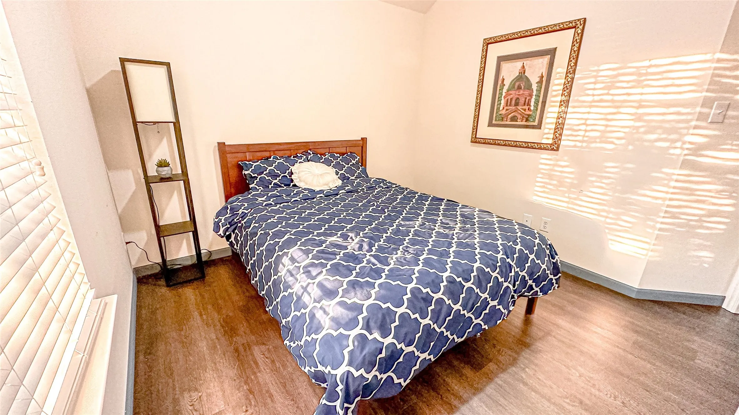 Bedroom featuring wood finished floors and baseboards
