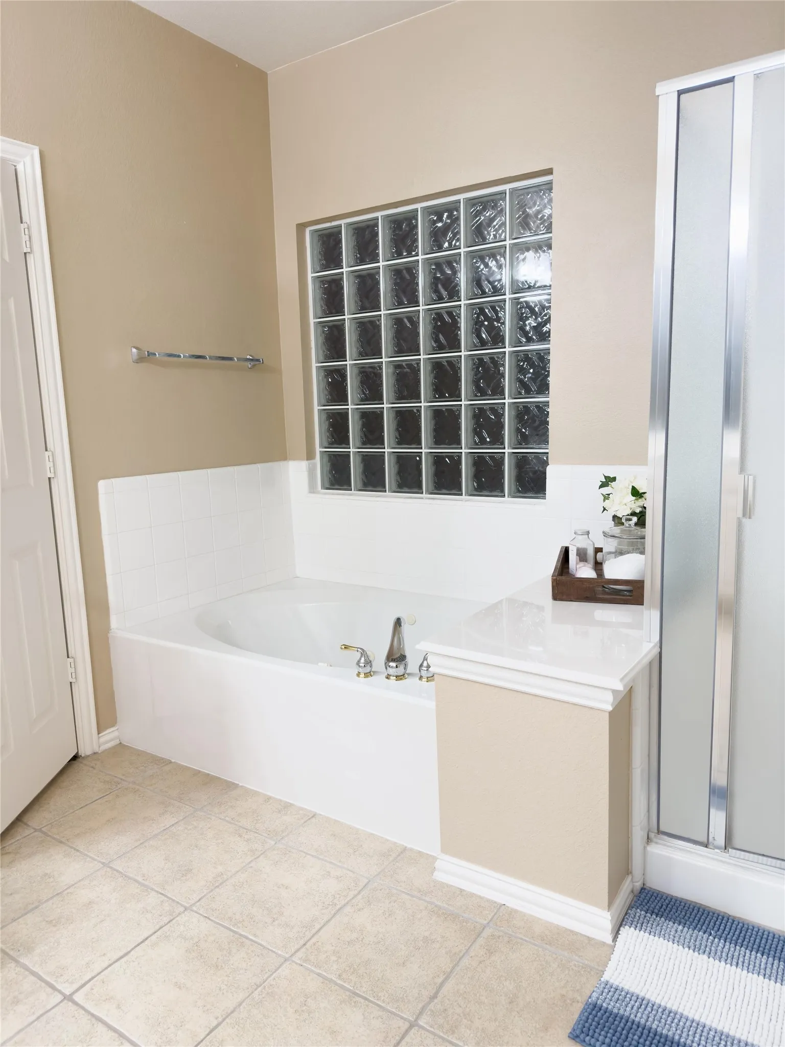 Bathroom with a shower stall, a bath, and tile patterned floors