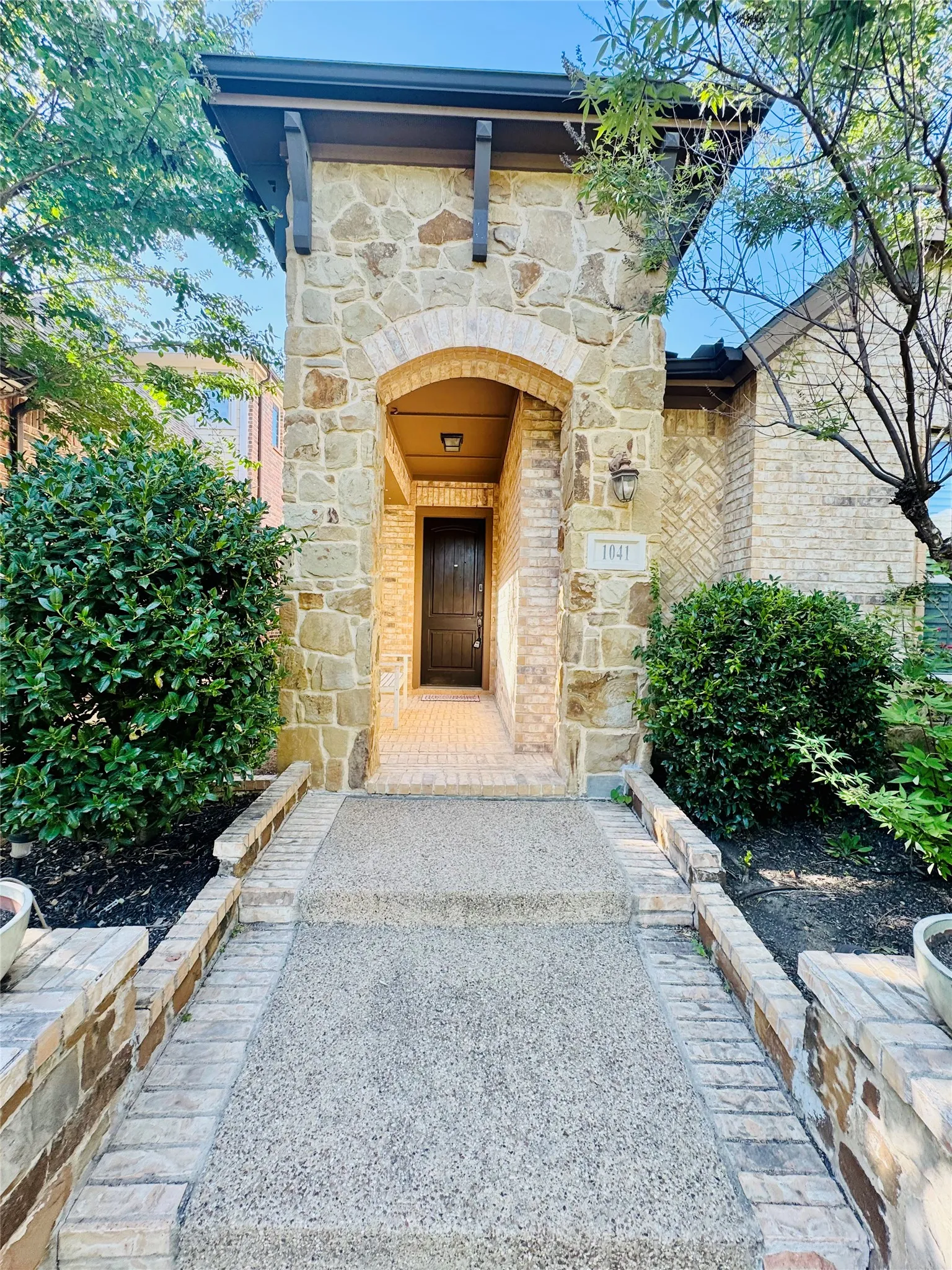Stone and brick façade with an arched entryway