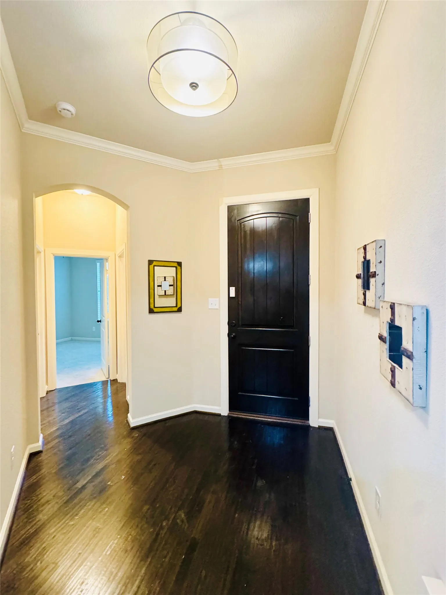 Hardwood flooring, arched doorway, recessed lighting, crown molding, drum pendant light fixture