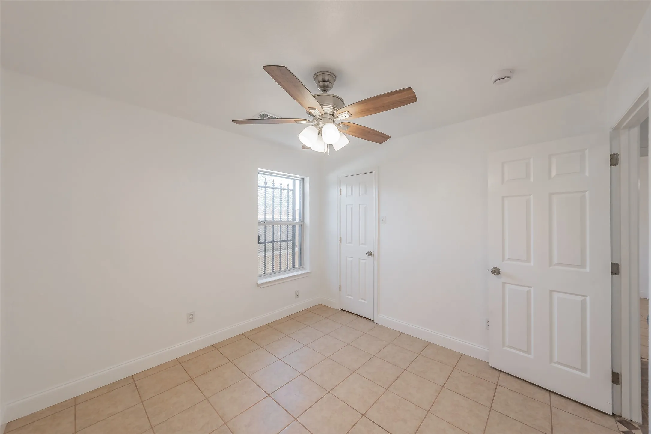 Recessed lighting, ceiling fan with wood-finish blades, white paneled doors, and tiled flooring