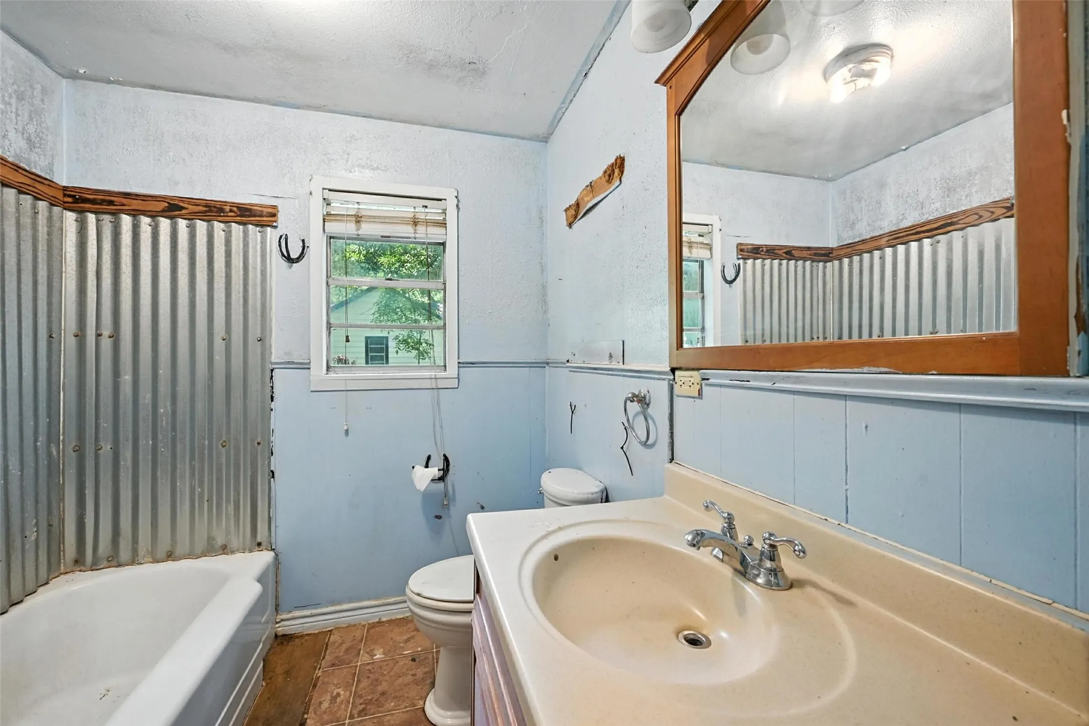 Full bath featuring vanity and dark tile patterned floors