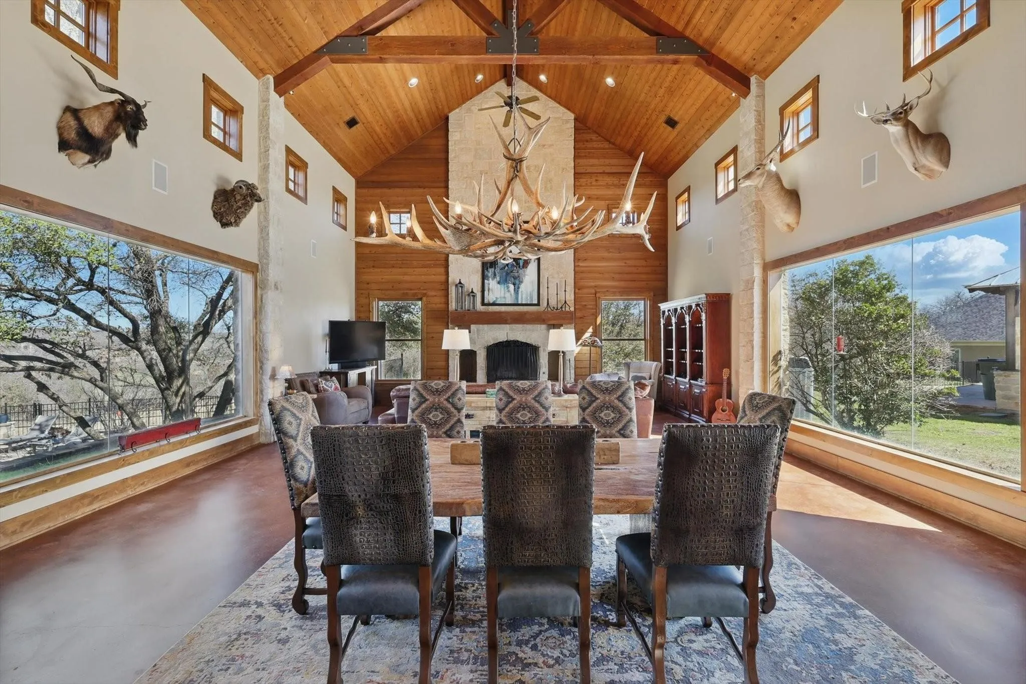 Dining room with wood ceiling, concrete flooring, vaulted ceiling, and recessed lighting.