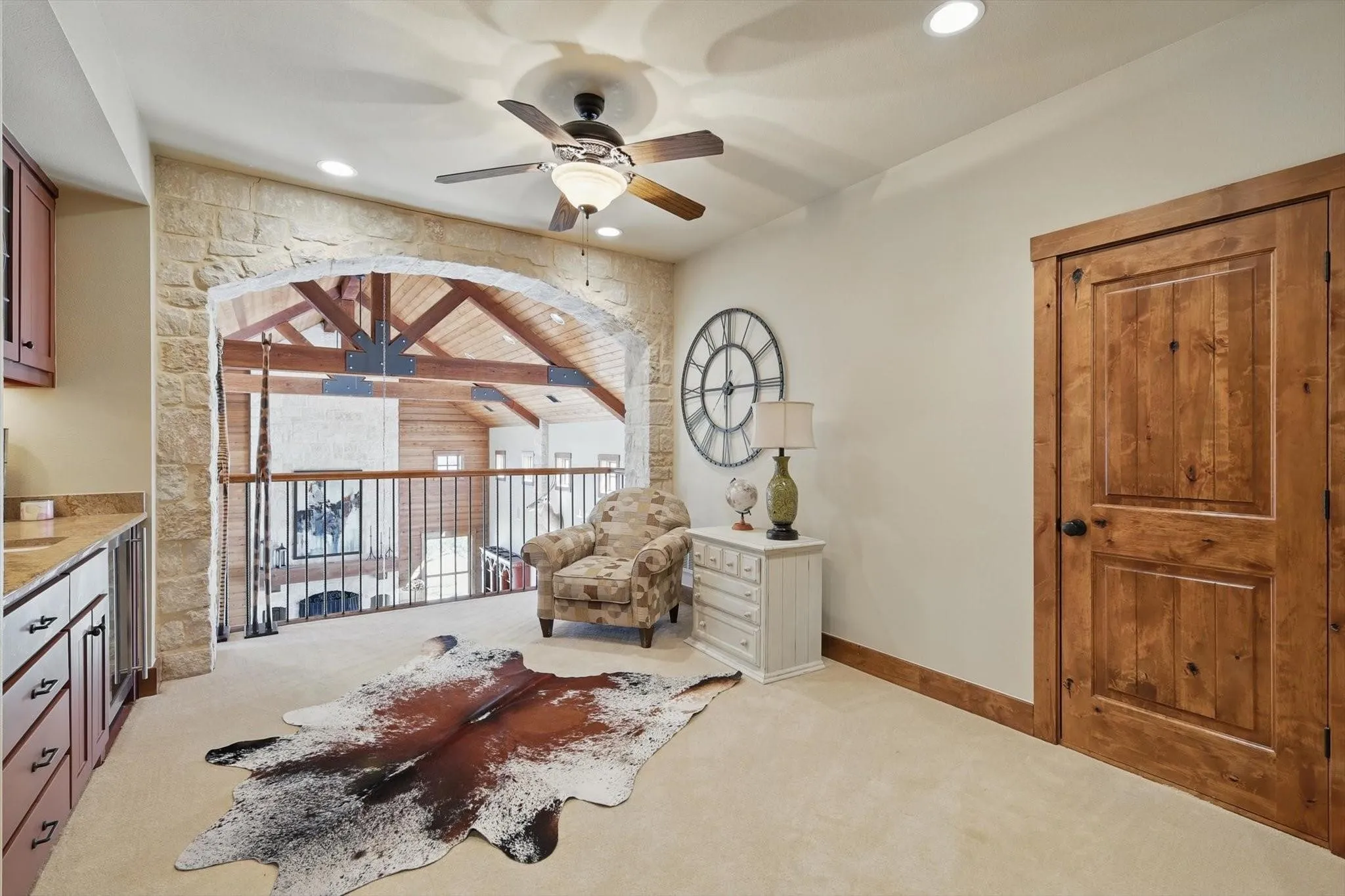 Sitting room with light carpet, ceiling fan, and recessed lighting.