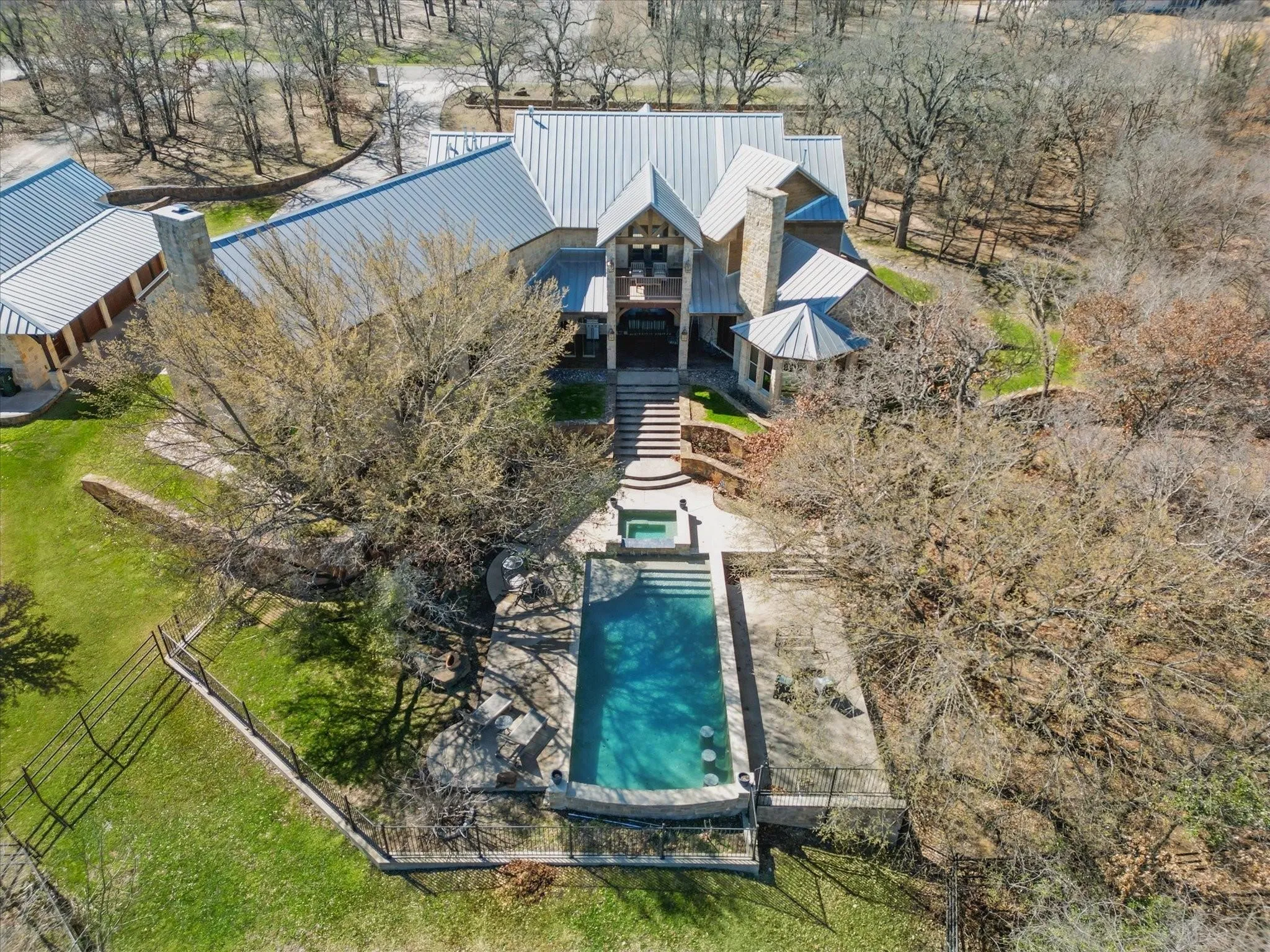 Pool view with patio area and fenced backyard.