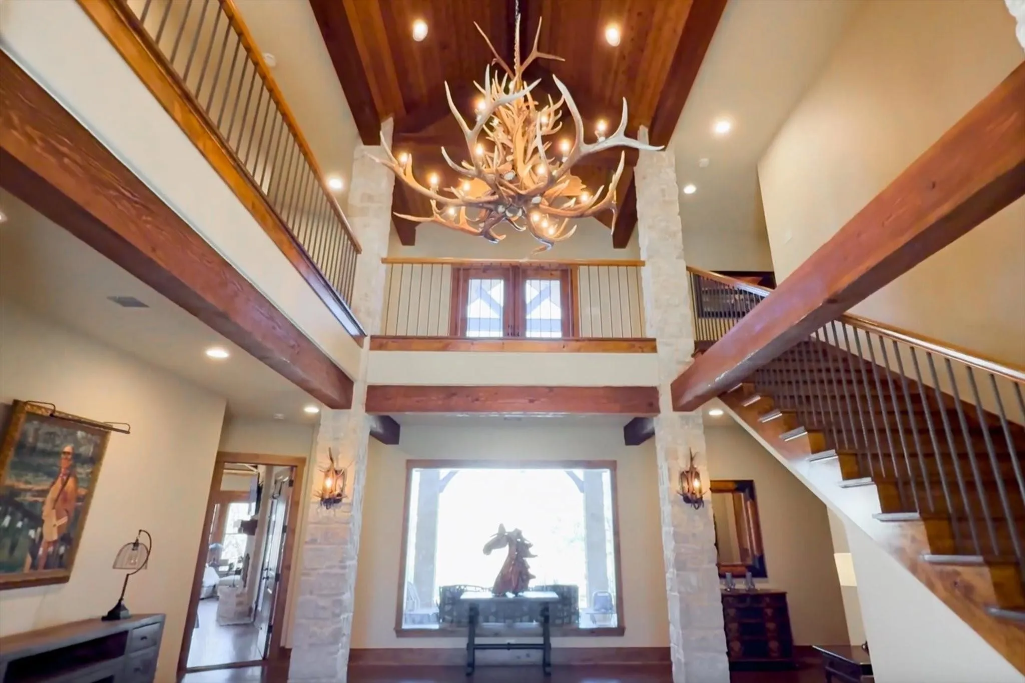 Entryway with recessed lighting, high ceiling, stairway, and chandelier.