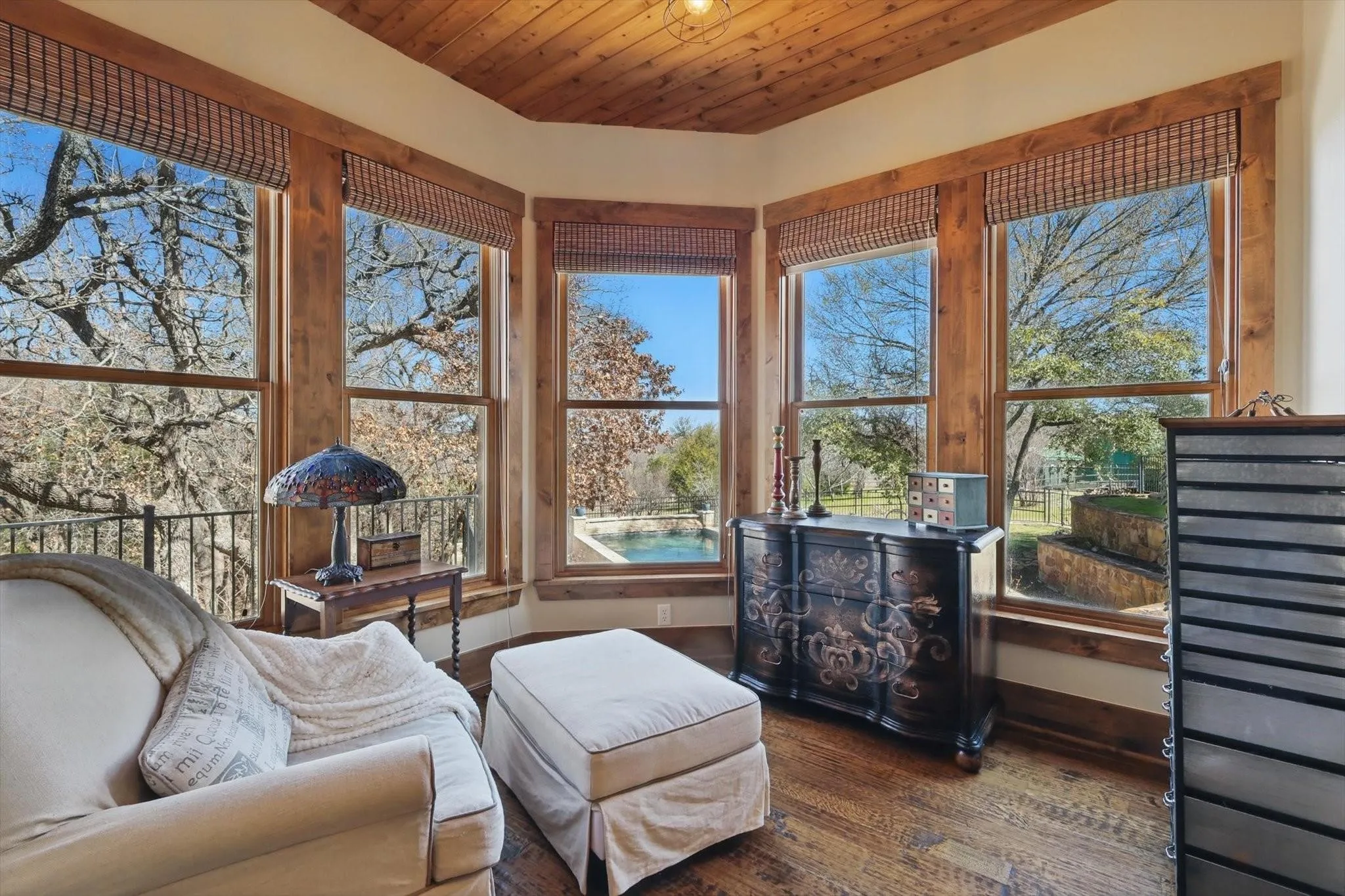 Sunroom/solarium with abundant natural light, wood ceiling, and wood-finished floors.