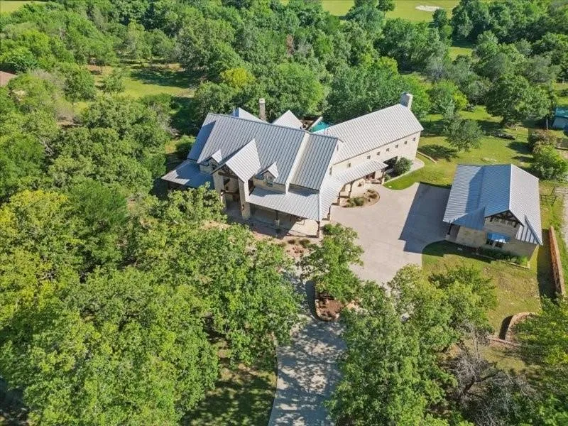 Aerial view of the property and surrounding landscape.