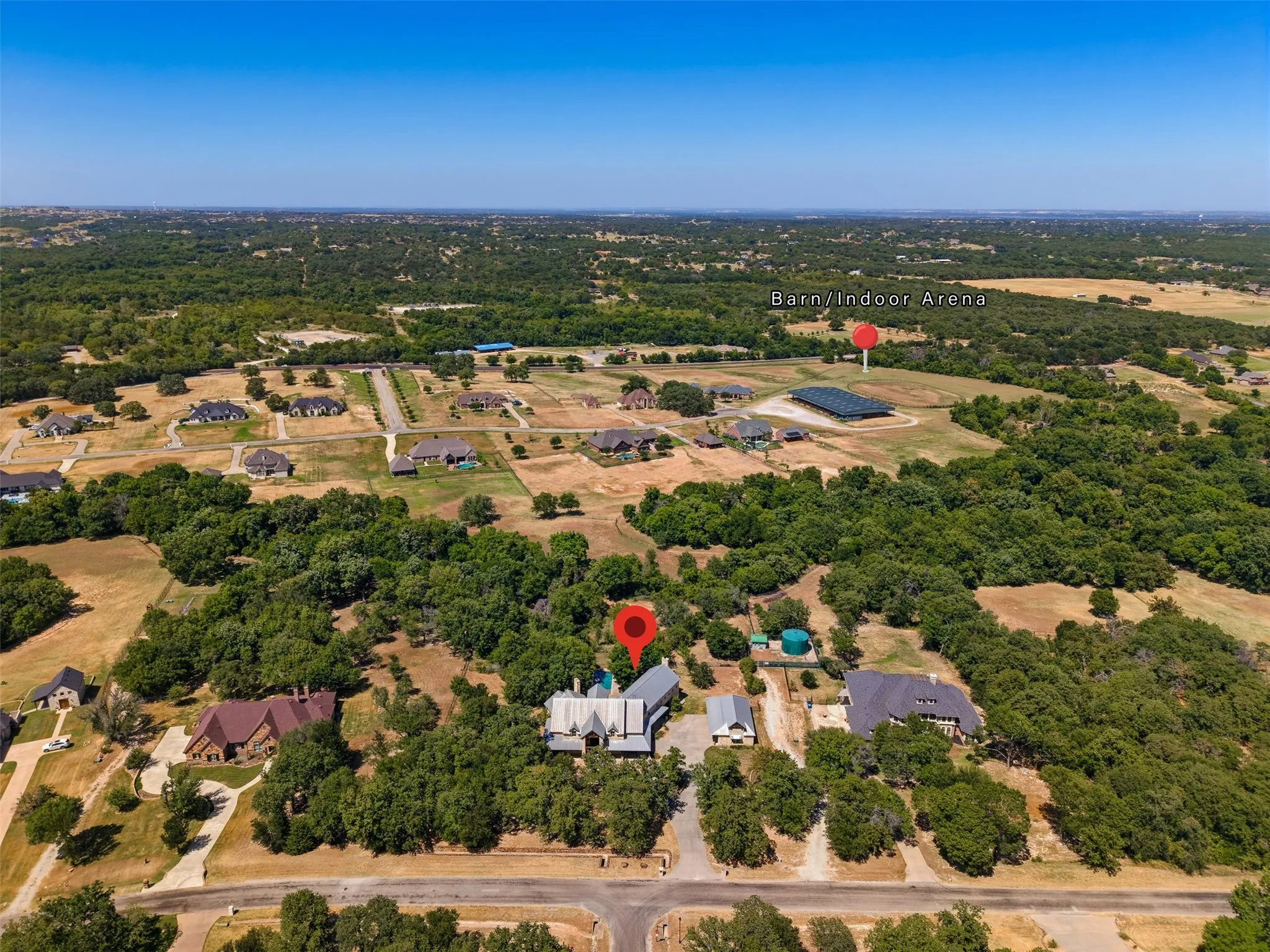 Distant perspective from the property showcasing the barn/indoor arena.