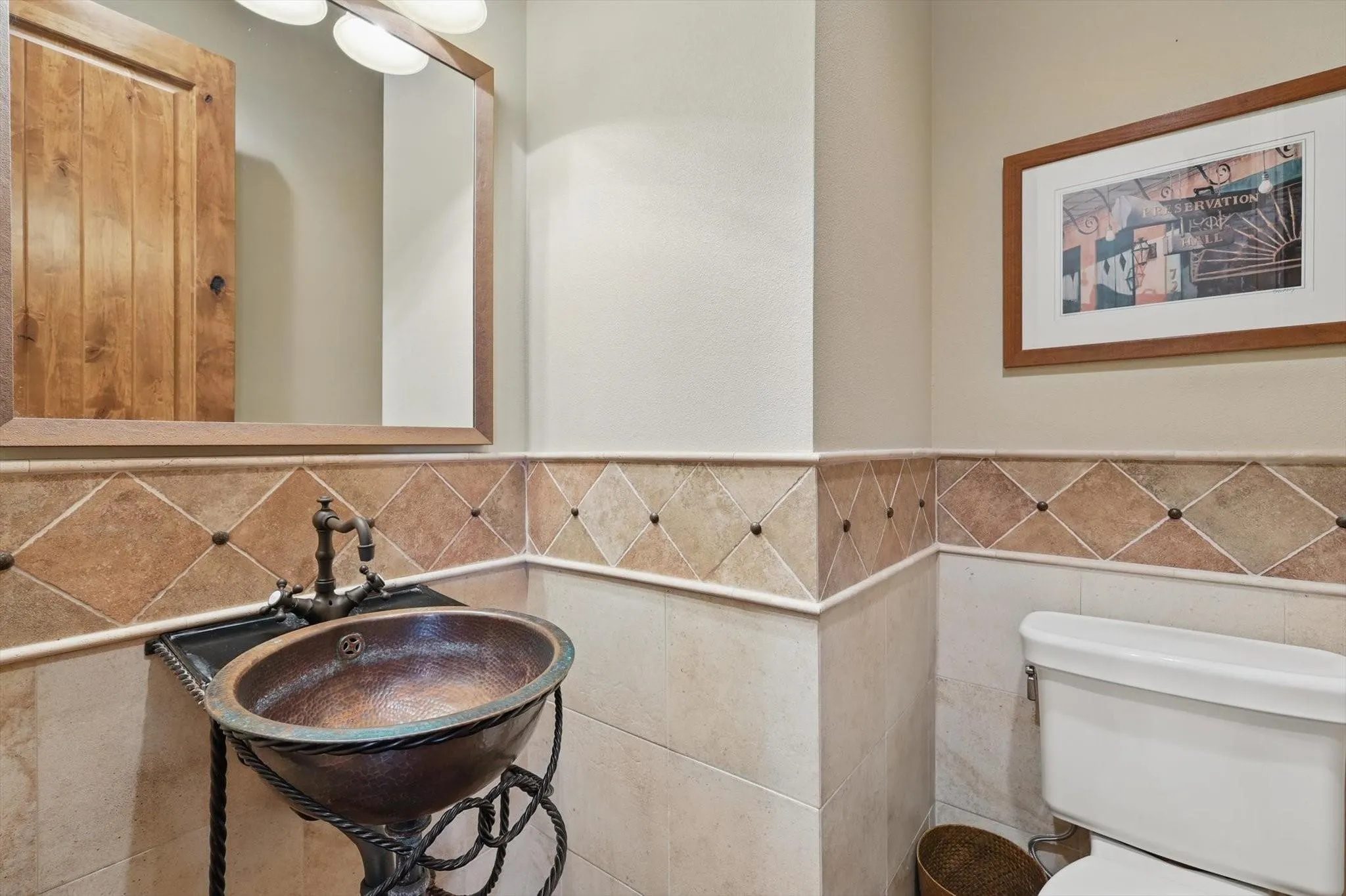 Half bath with sink and tile walls.