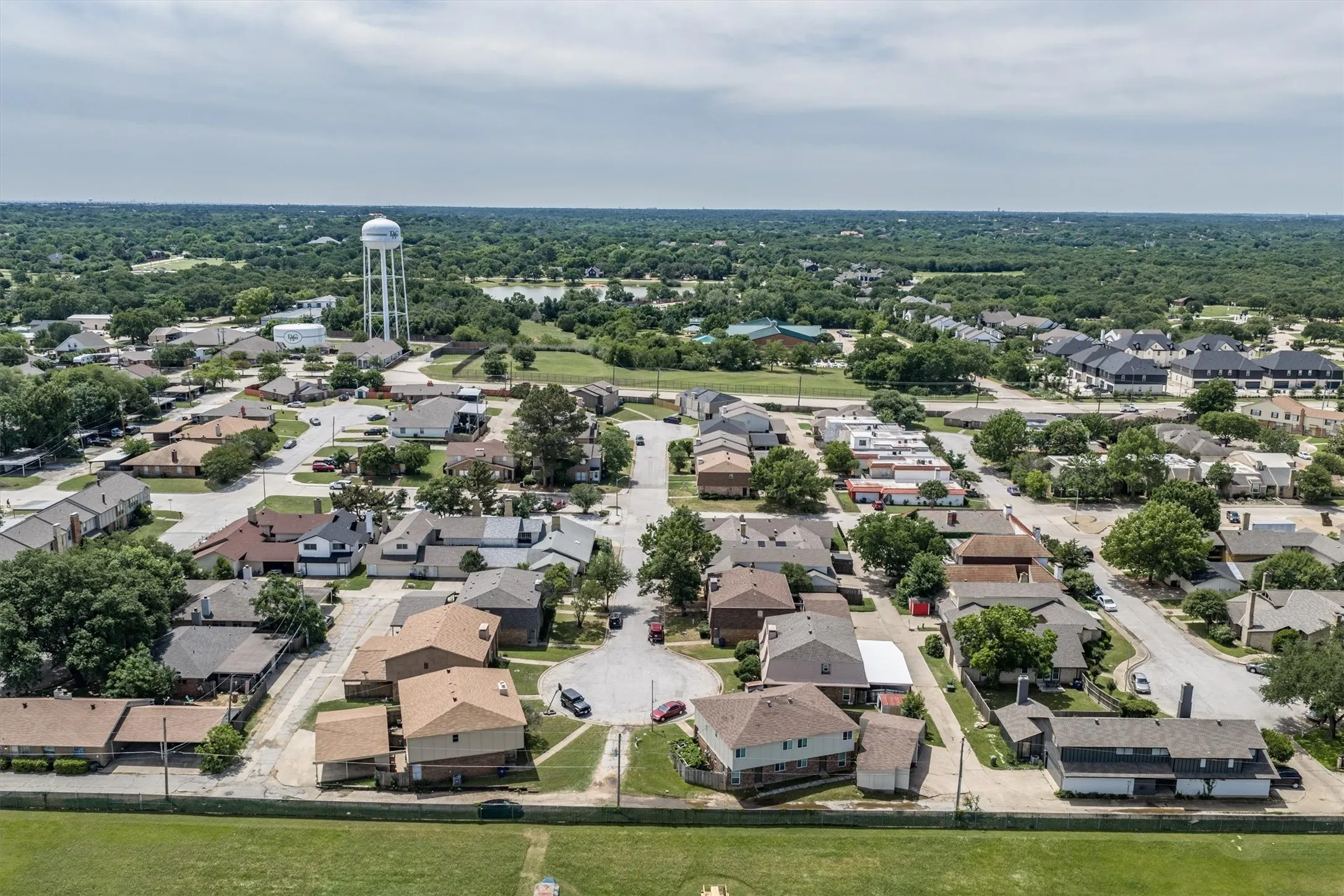 Aerial perspective showcasing a residential community with mature trees and varied architectural styles