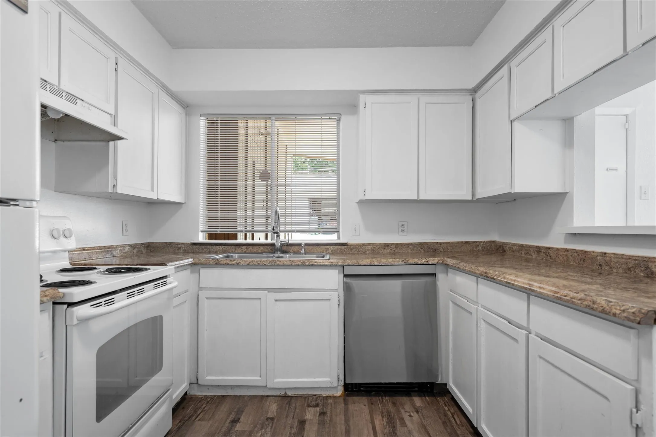 White cabinetry and wood-finish flooring