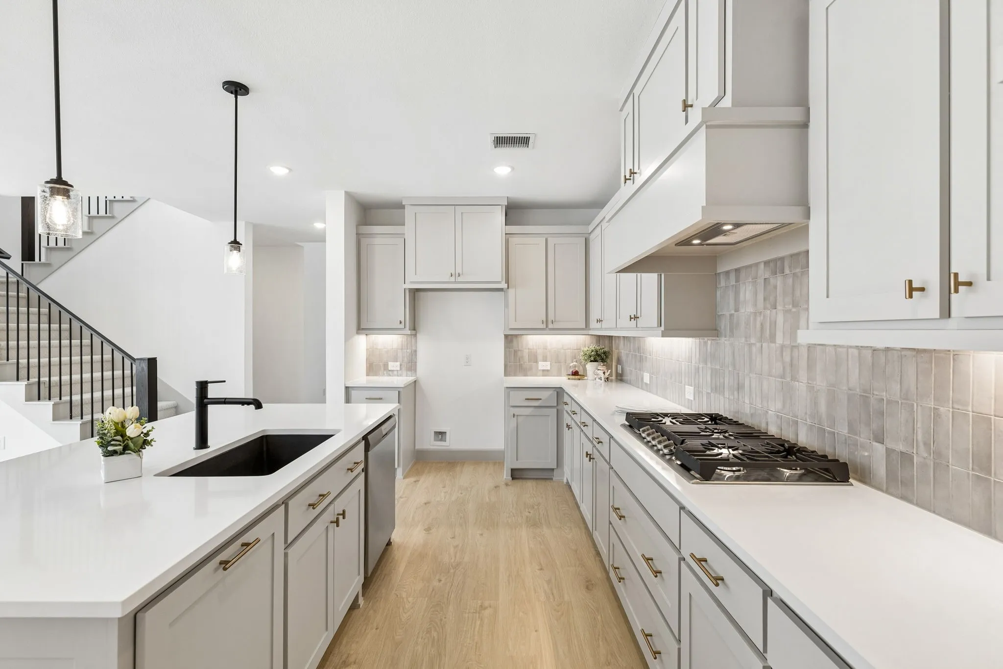 Beautiful cabinetry paired with a designer backsplash and gorgeous countertops make this kitchen standout from the crowd!