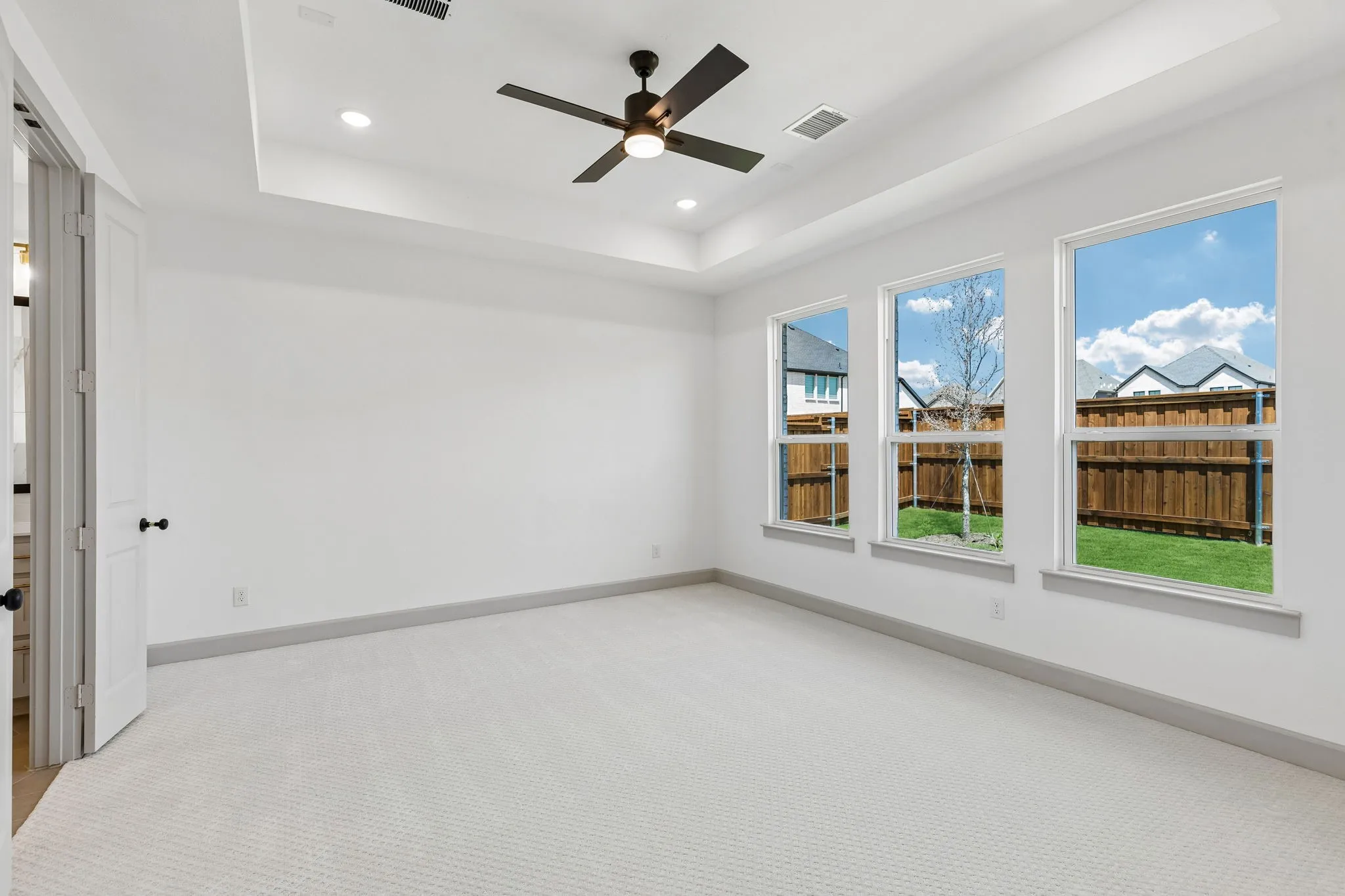 With large windows over looking the private back yard, lush carpeting and high ceilings, this owner's suite is a dream come true!