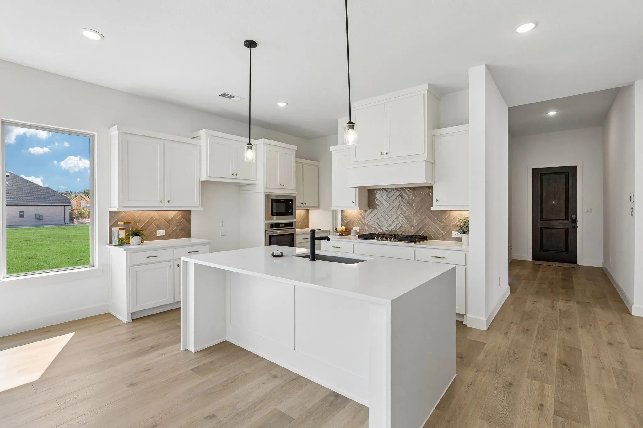 Light, bright and airy, this open concept kitchen-dining-family room is everything you have been searching for!