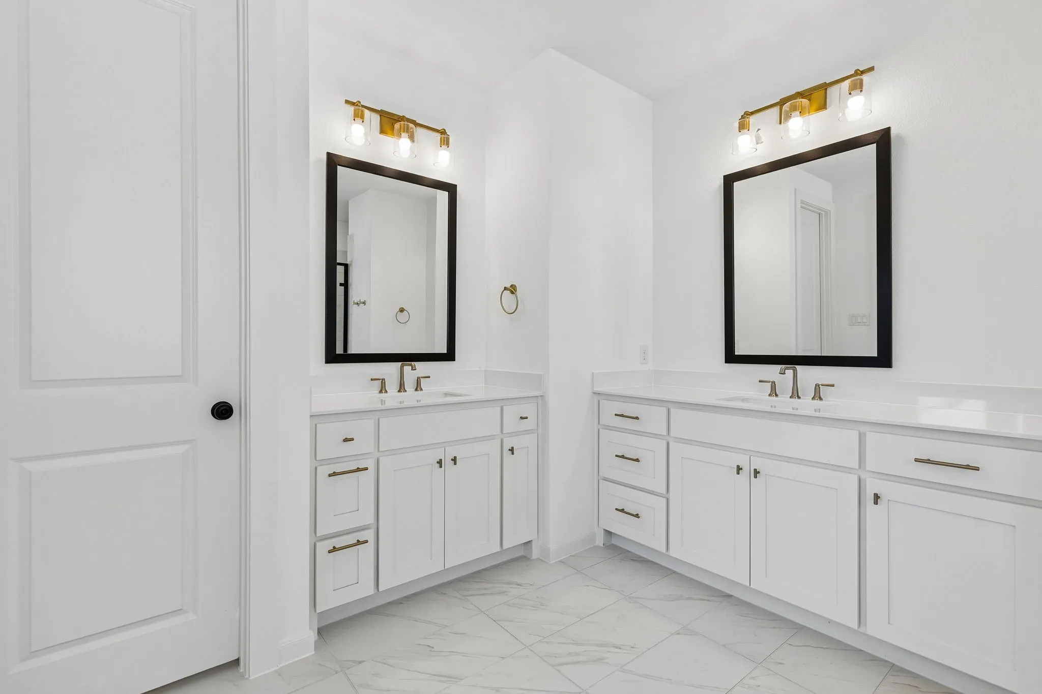 His and her vanities are just one of the many sought after features in this lovely owner's bath.