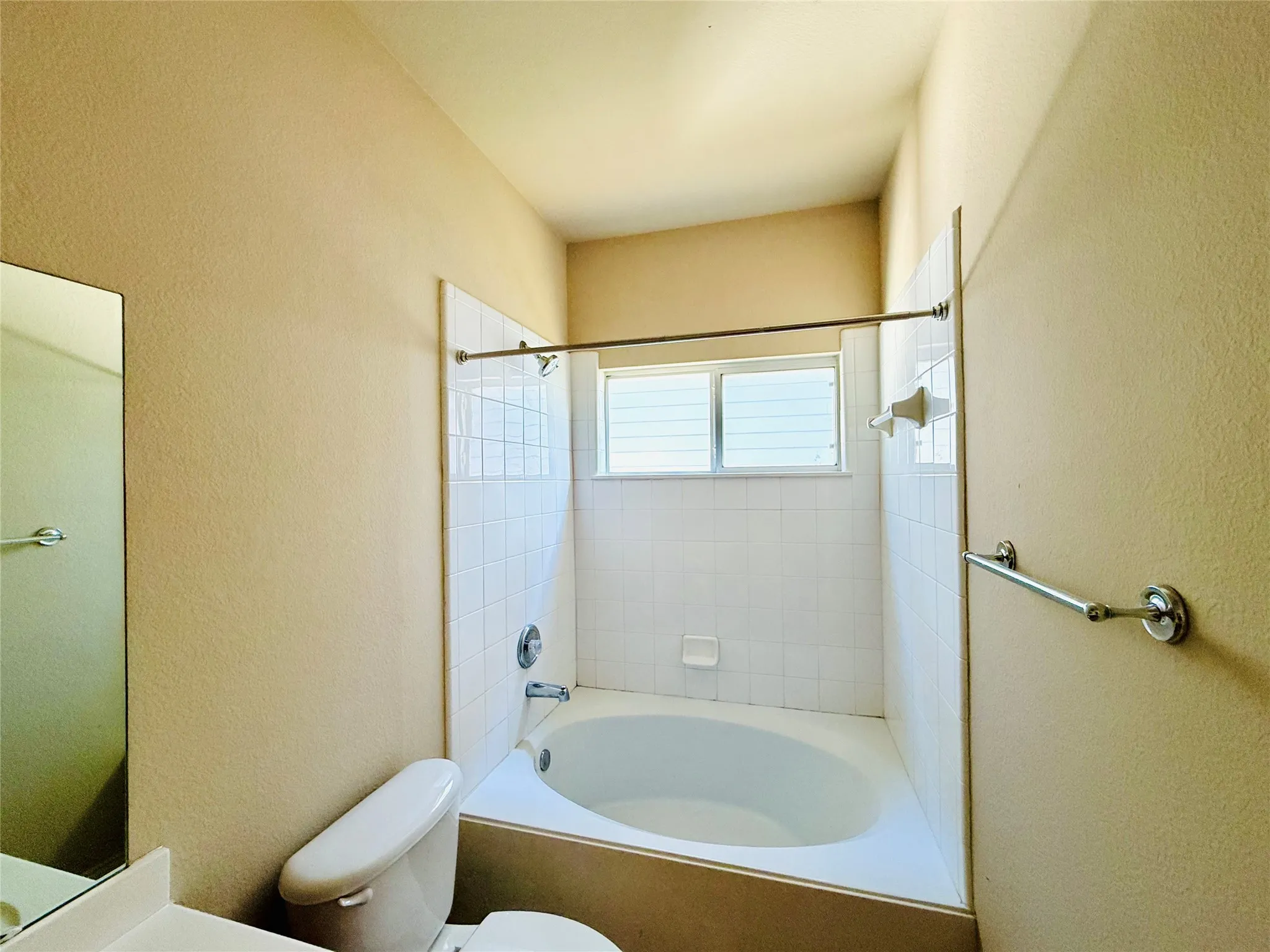 Bathtub with white subway tile surround and chrome fixtures