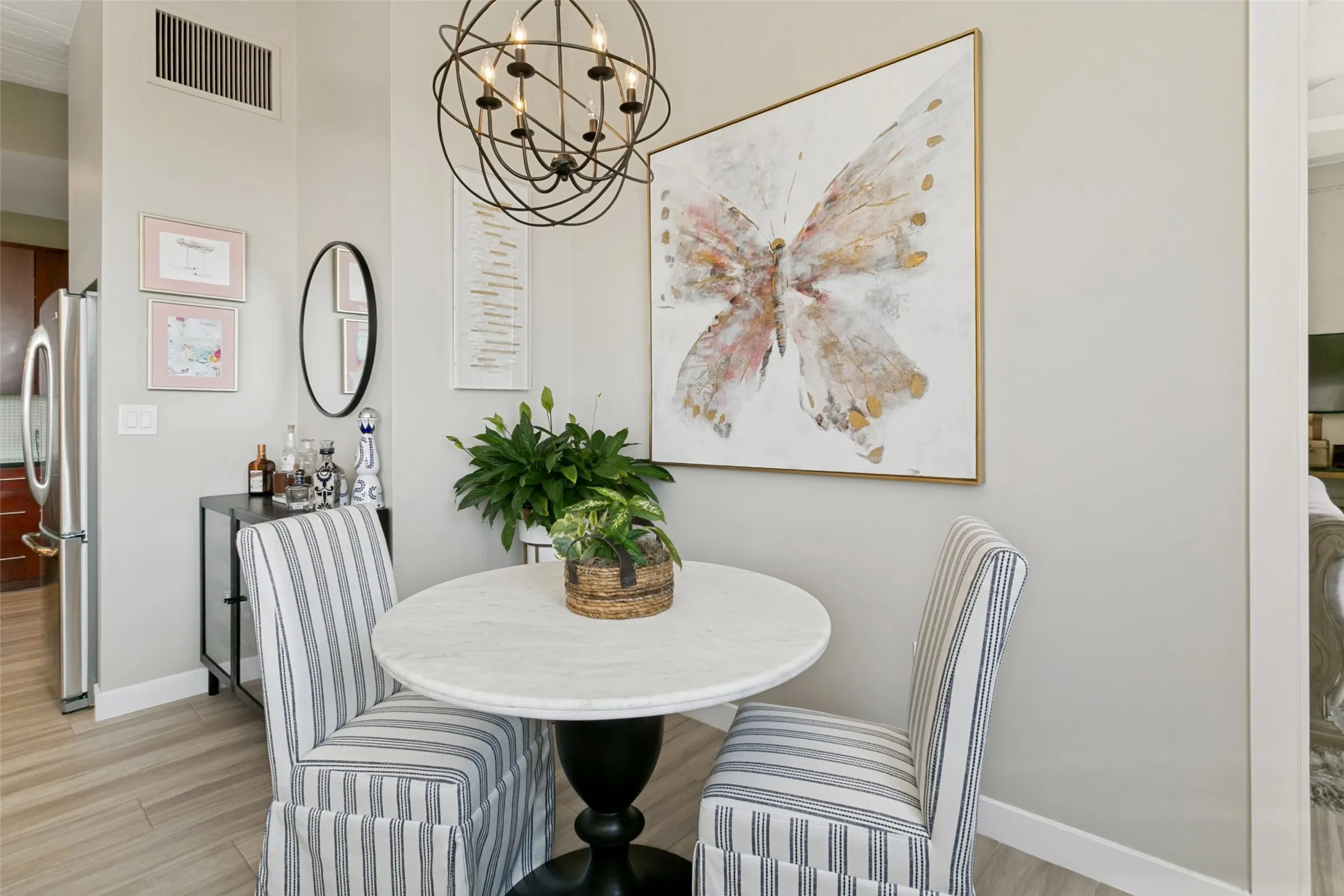 Dining area featuring porcelain wood-look flooring, and a spherical chandelier