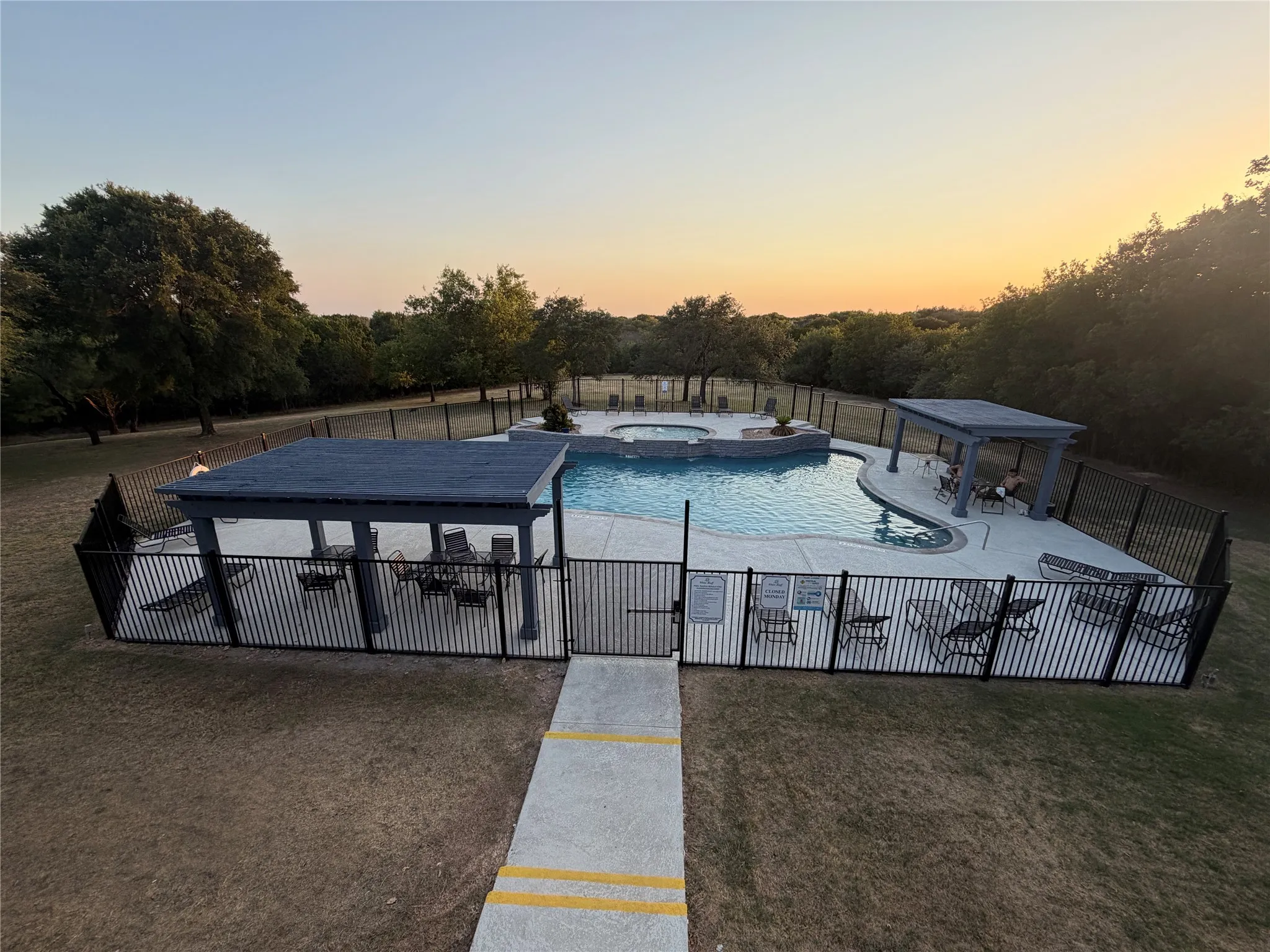 One of the four pools managed by the HOA at twilight