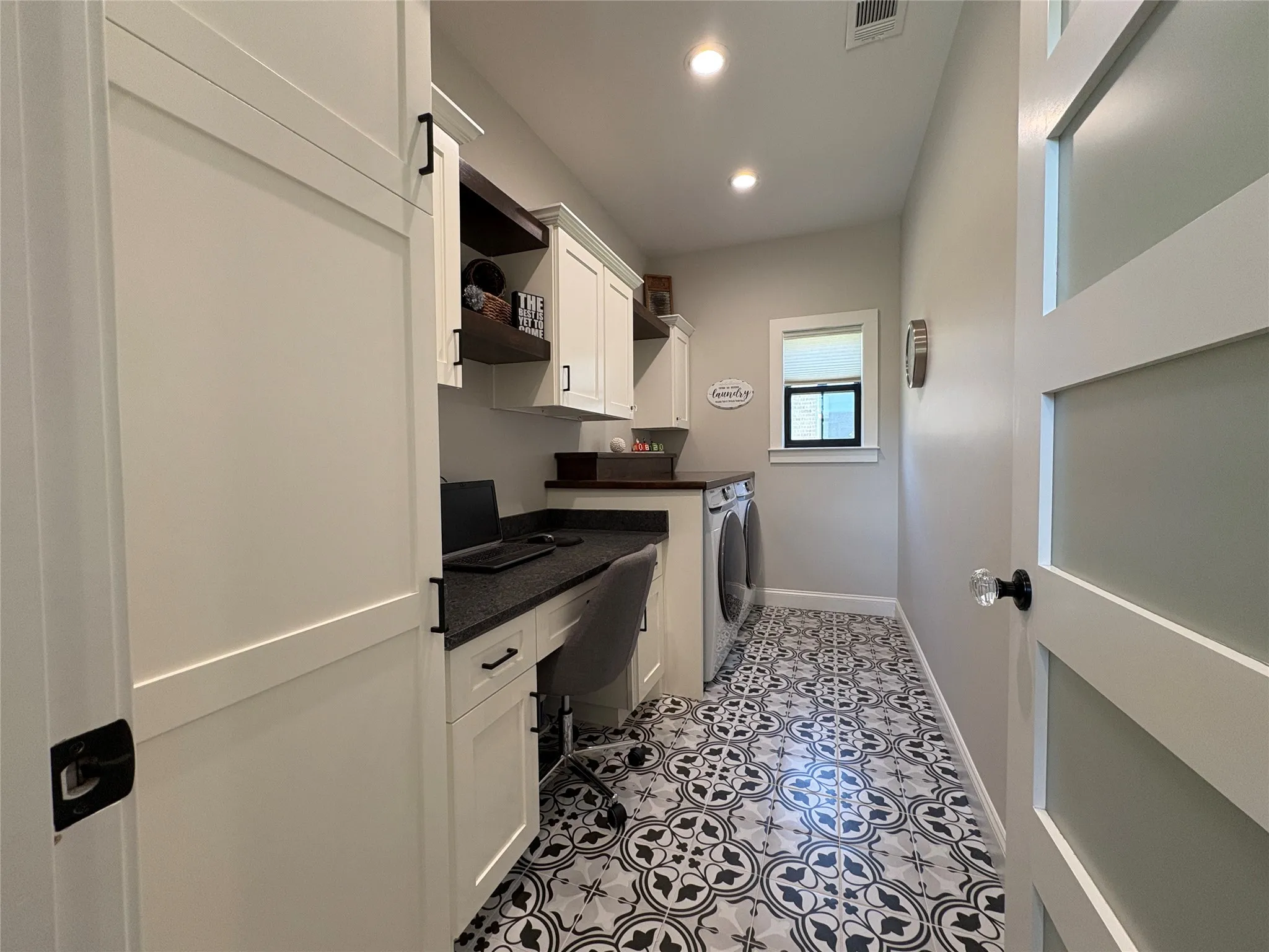 Laundry room with work station and shelving