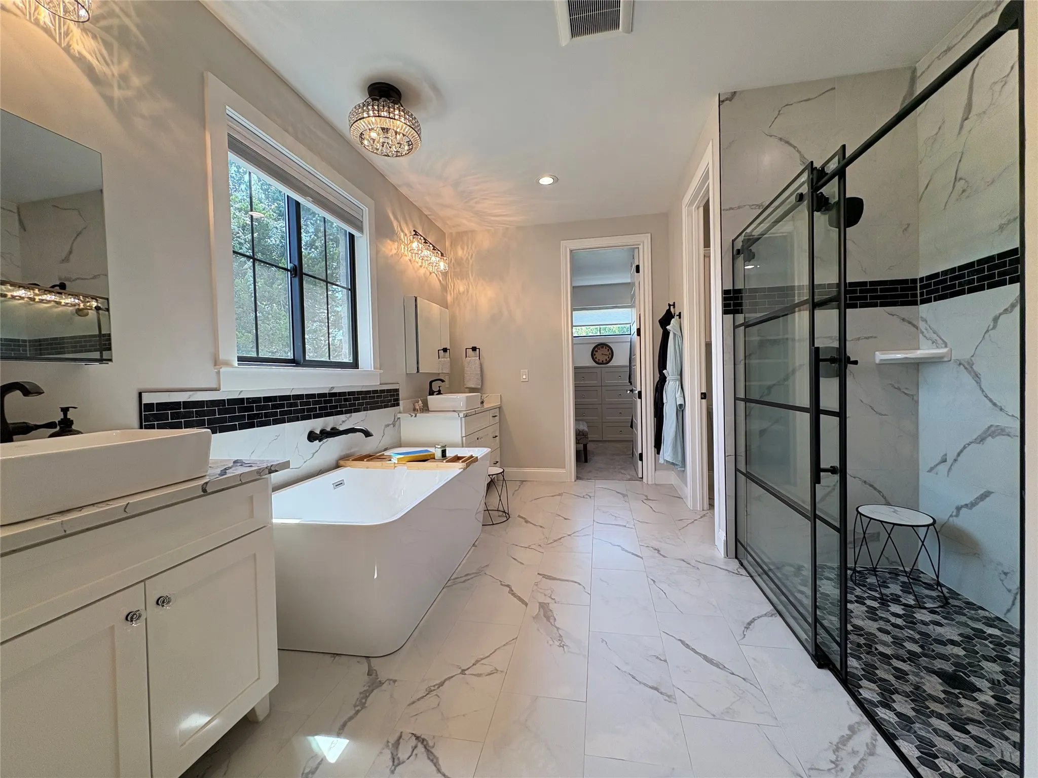 Spacious primary bathroom with many custom features