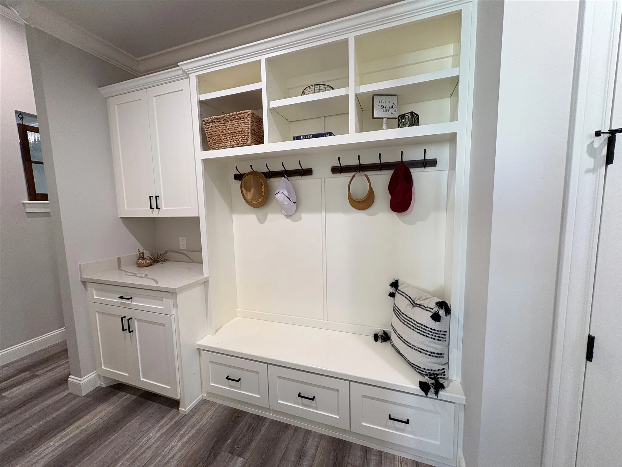 Mudroom near garage entry with shelving and storage space