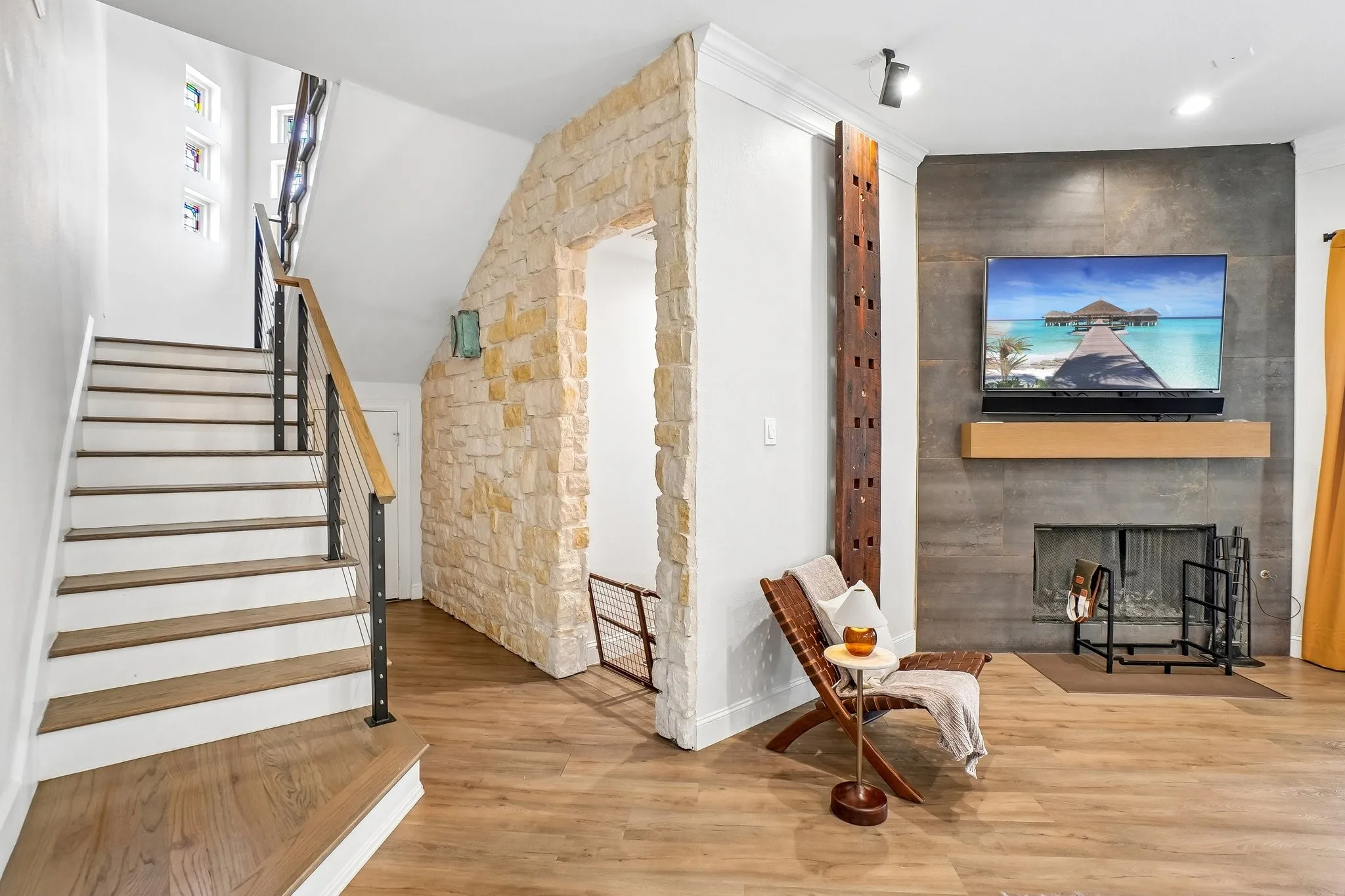 Stairway leading upstairs to one of two primary suites.