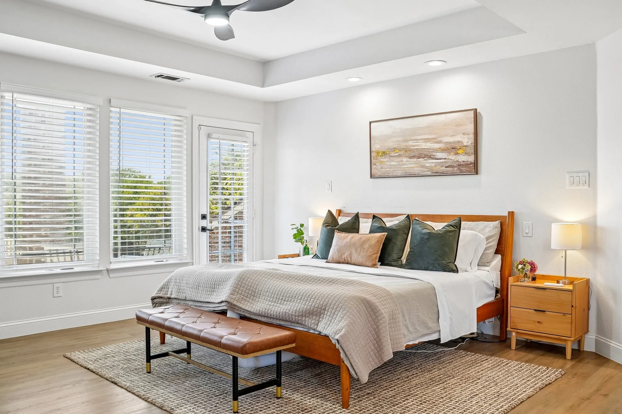 Recessed lighting, tray ceiling, wood-finish flooring, ceiling fan, and abundant natural light