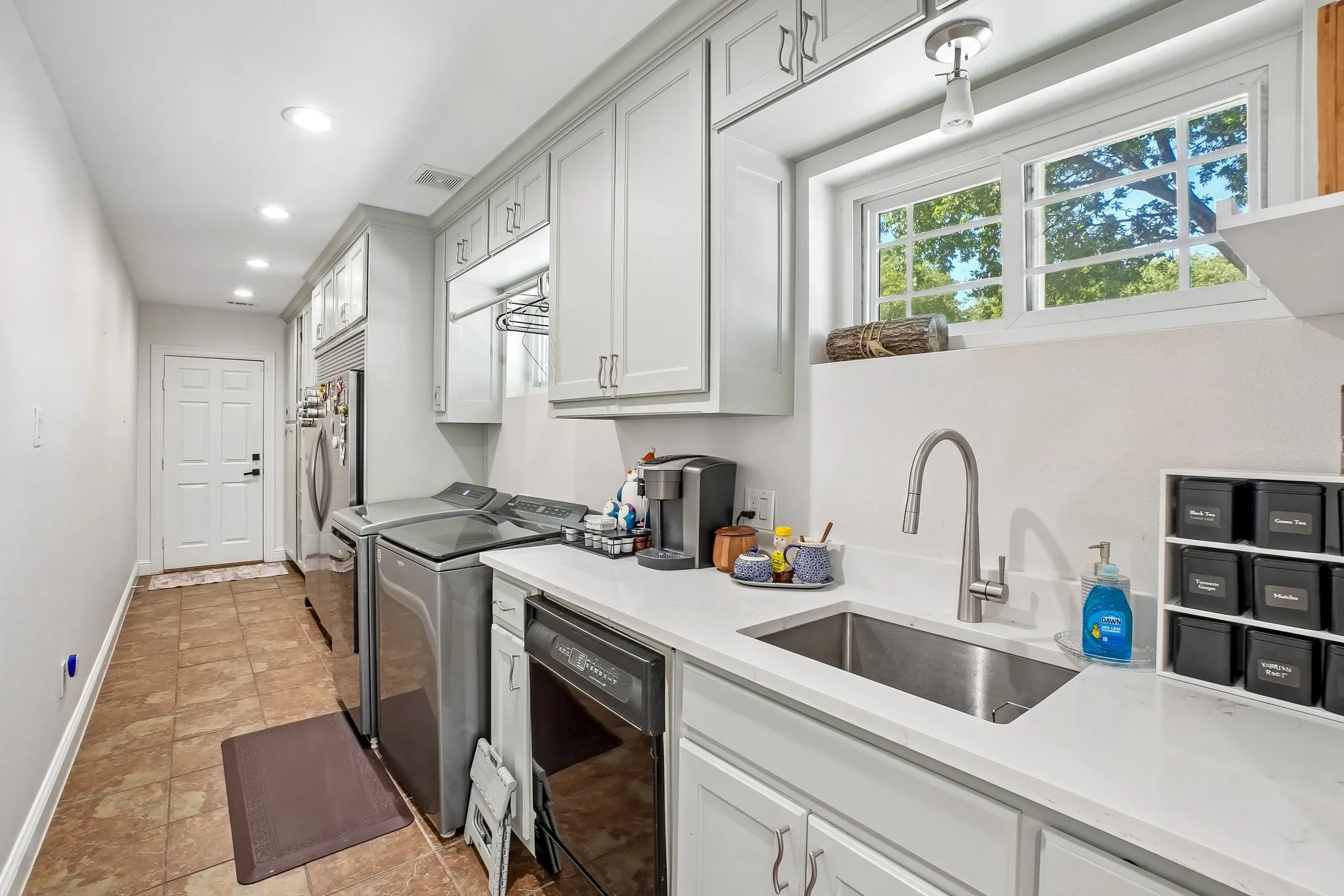 Amazing huge laundry room with an extra dishwasher and refrigerator/freezer.