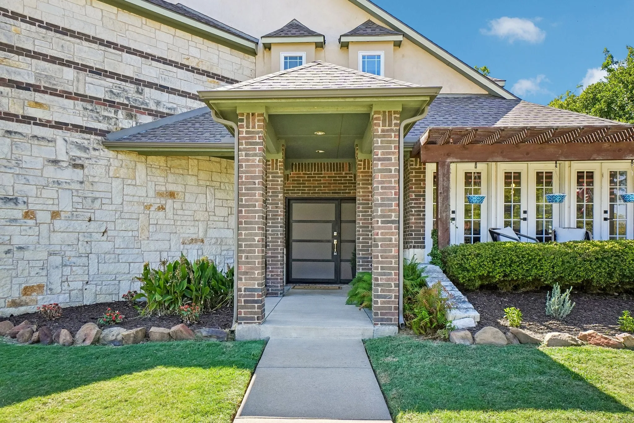 Brick and stone exterior with a covered entry
